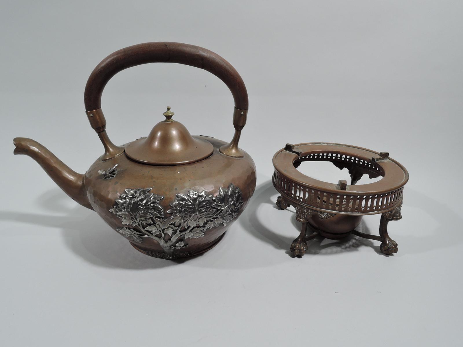 Japonesque mixed metal kettle on stand. Made by Gorham in Providence, ca 1880. Kettle: Round and tapering body with s-scroll spout. Applied silver ornament on hand-hammered copper ground. On one side a rooster clucks and pecks on granulated soil; on