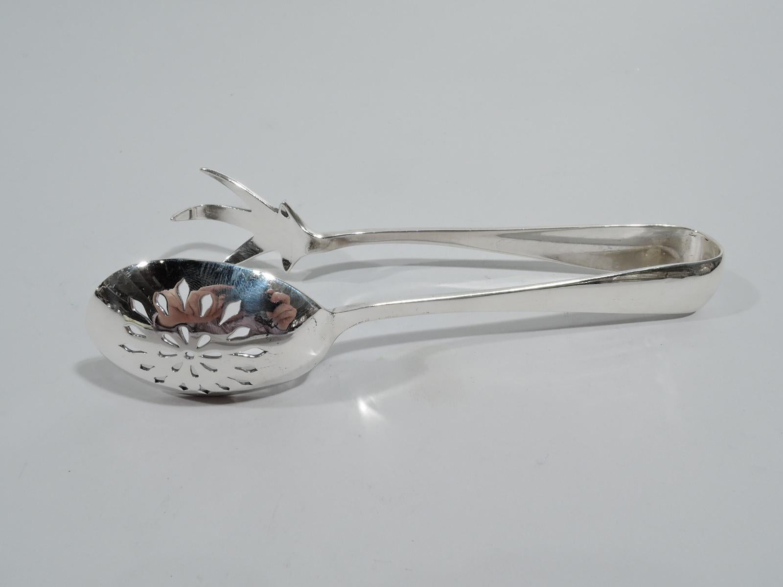 Mid-Century Modern sterling silver ice tongs. Made by Gorham in Providence. U-form with talon jaw and round bowl with concentric piercing. Fully marked. Weight: 2.4 troy ounces.