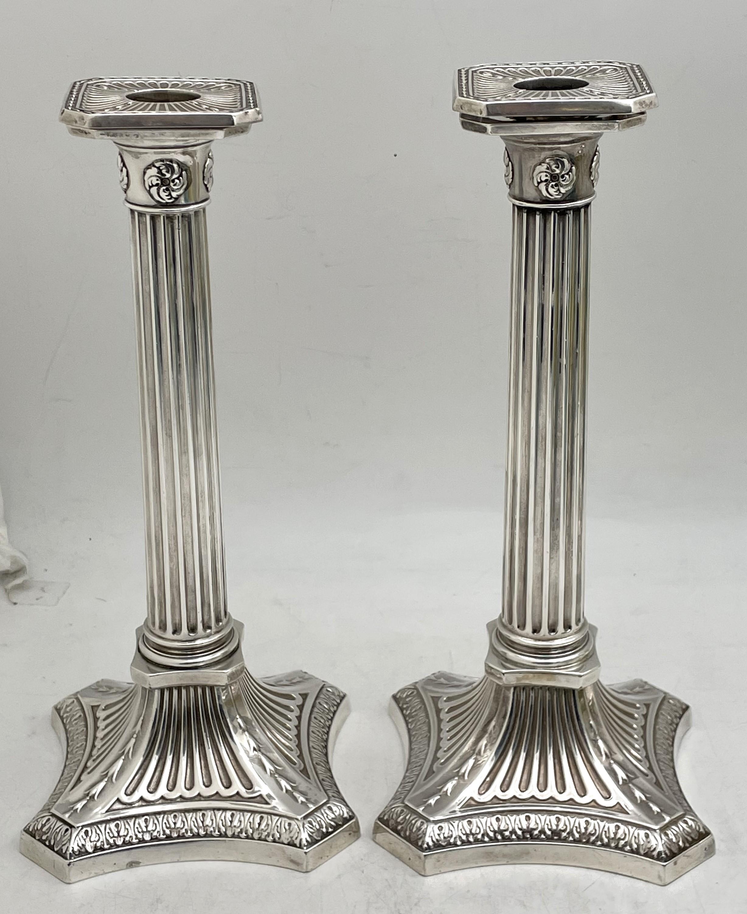 Gorham pair of sterling silver candlesticks from 1894, designed as Corinthian columns, with an elegant design and with removable bobeches. They measure 10 1/4'' in height by 4 1/2'' in depth at the base, are weighted, and bear hallmarks as shown.