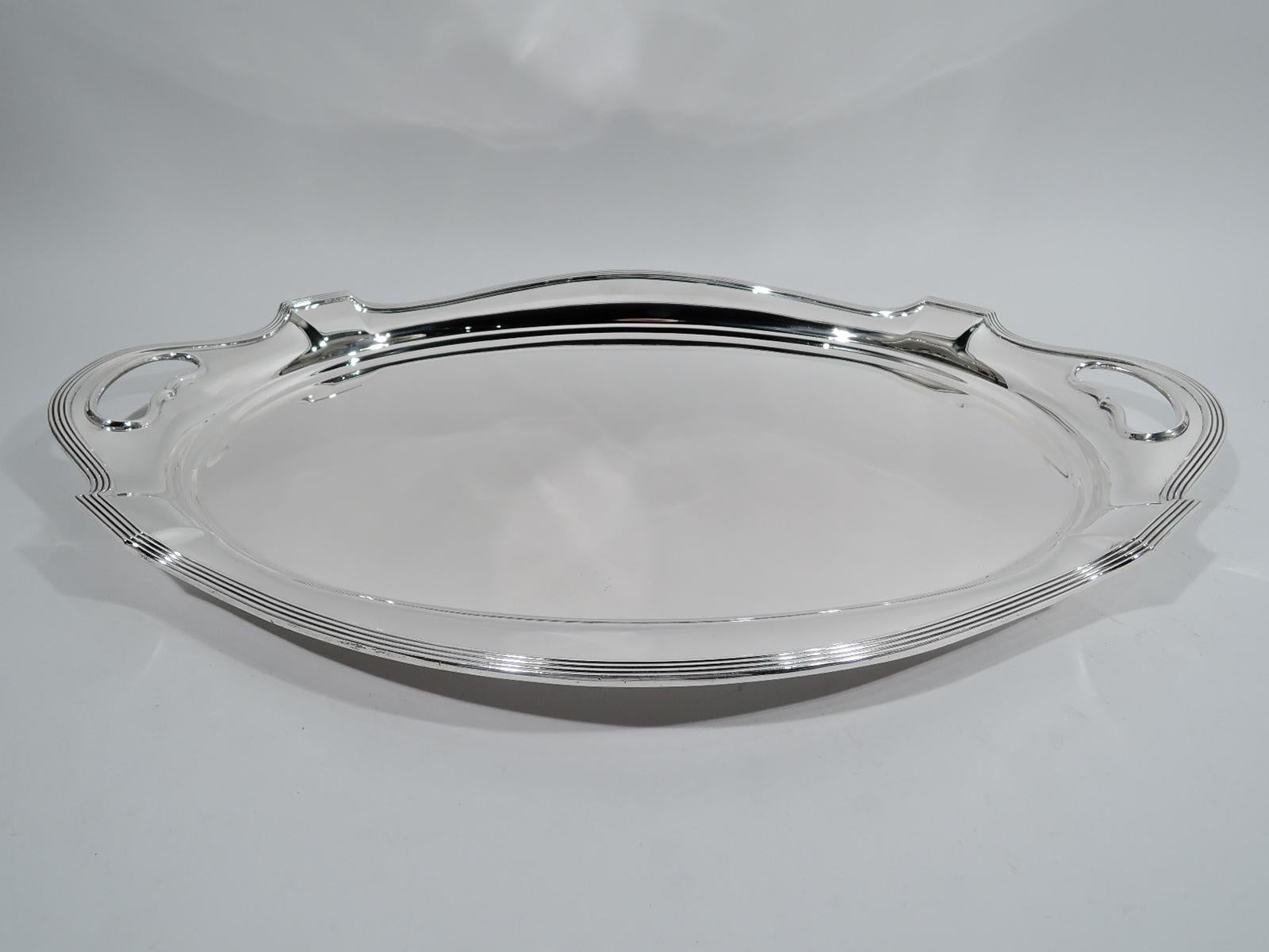 Plymouth sterling silver tea tray. Made by Gorham in Providence in 1950. Oval well and reeded and curvilinear rim; cutout kidney end handles. Fully marked including maker’s stamp, date code, and pattern name and no. 2816. Weight: 106 troy ounces.