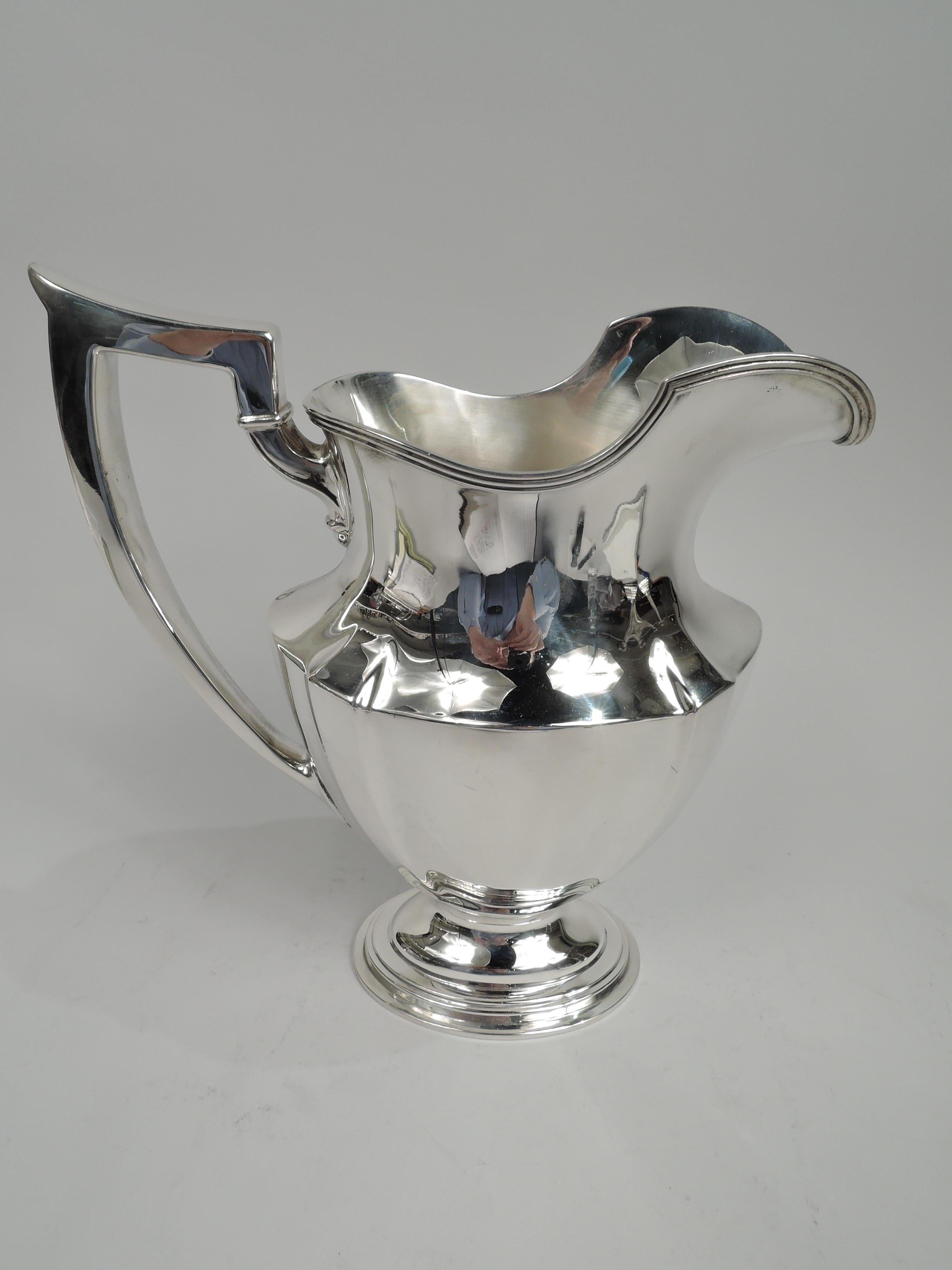 Plymouth sterling silver water pitcher. Made by Gorham in Providence in 1948. Tapering and paneled ovoid body, reeded helmet mouth, capped scroll bracket handle, and stepped oval foot. A nice piece in the classic pattern. Fully marked including