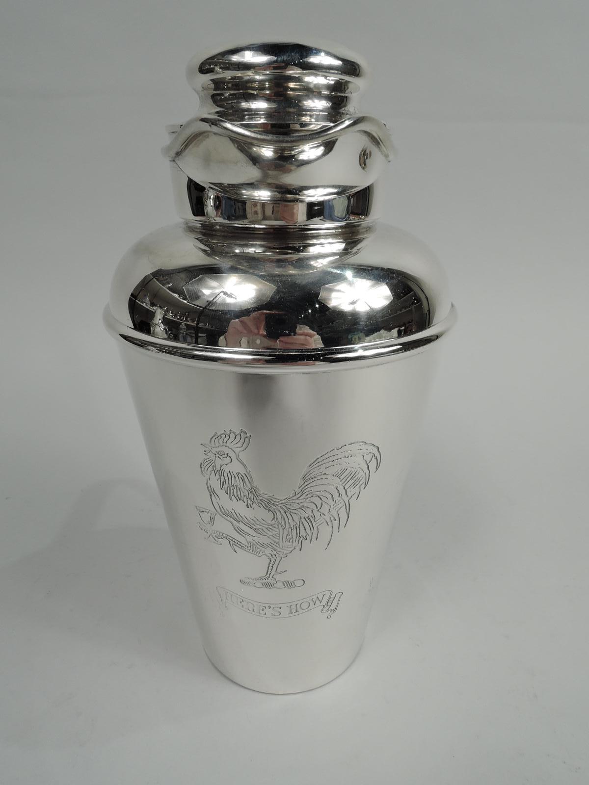 Prohibition-era sterling silver cocktail shaker. Made by Gorham in Providence in 1925. Tapering bowl, curved shoulder, short neck, scroll bracket handle, and helmet-mouth with snug-fitting bun cover and built-in strainer. On front is engraved