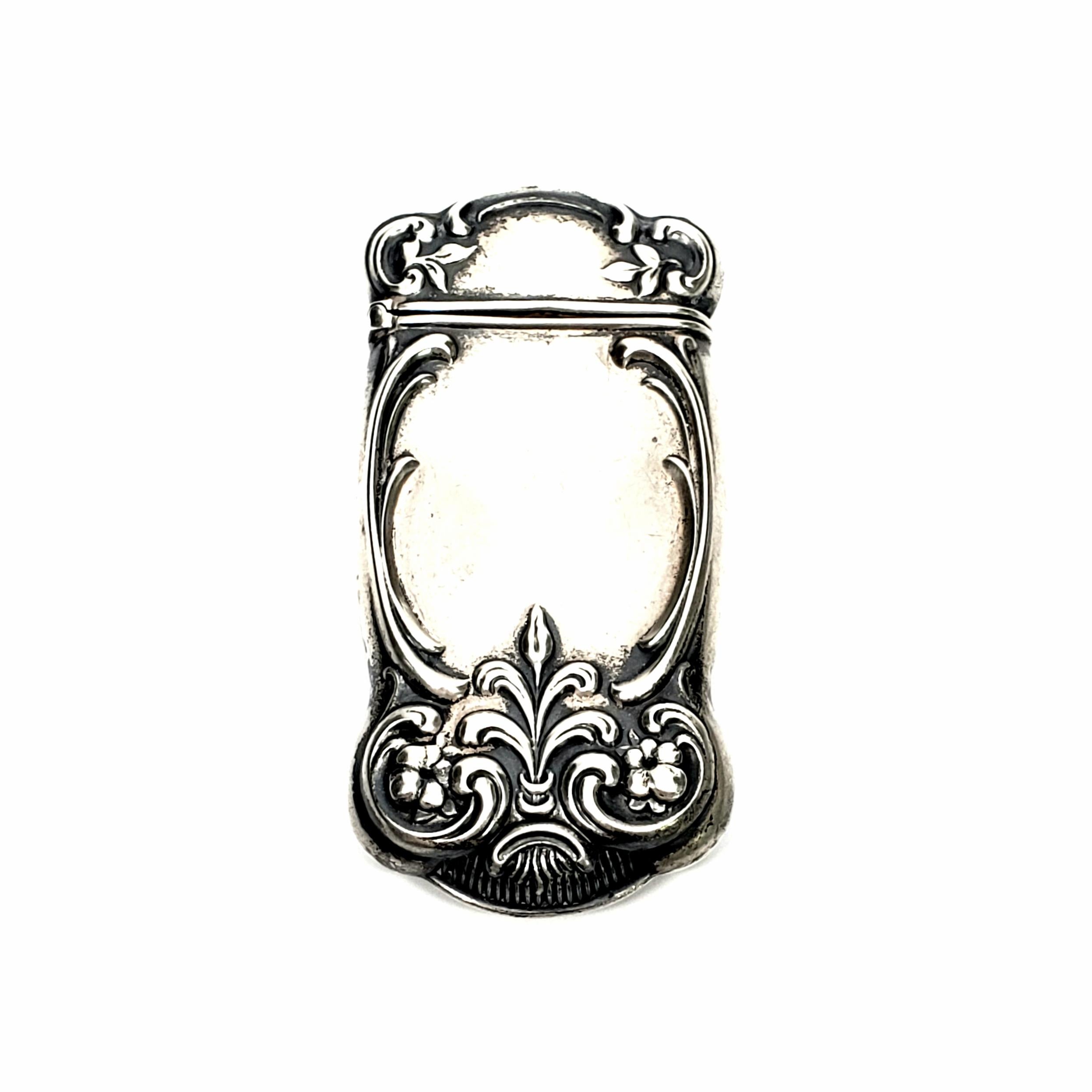 Antique sterling silver match safe/vesta case with monogram by Gorham #1170. Circa 1875-1899.

This beautiful piece features a repousse design of swirls, scrolls, small flowers and leaves. It has a well functioning hinge, and a striking surface on