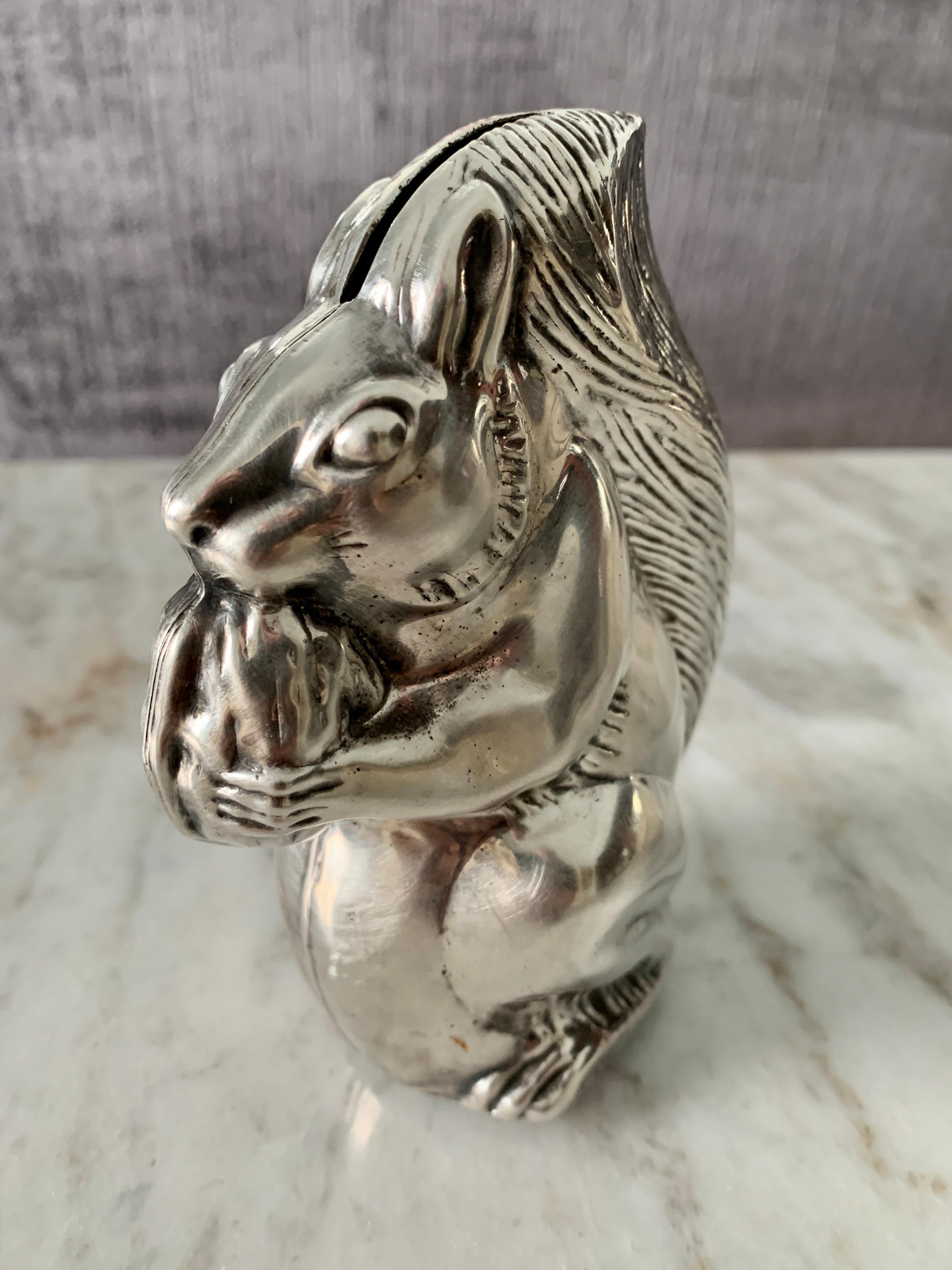 Perfect for a Childs room or baby gift. A silver plate Gorham Bank with squirrel and nut. The bank has a removable base to remove contents. The form is by a leader in Silverware, Gorham.

Gorham Silver was founded in Providence, Rhode Island, 1831