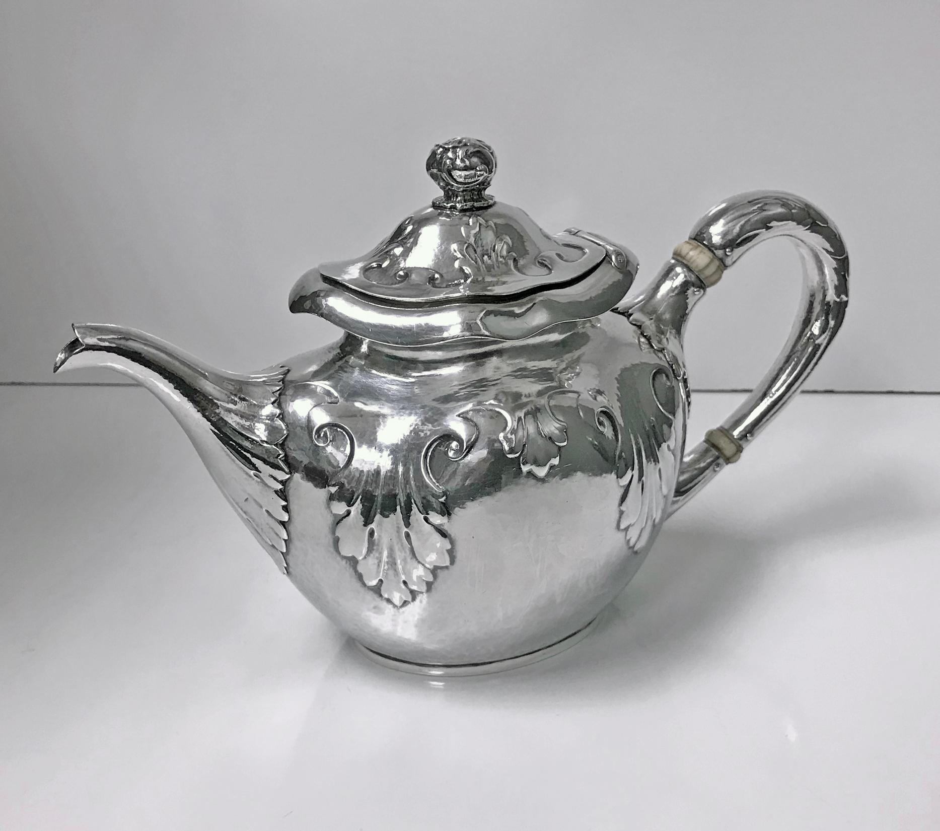 Rare design Gorham Sterling Art Nouveau Arts & Crafts hammered tea and coffee set. The set comprising coffee pot, teapot, covered sugar bowl, cream jug and waste bowl. All with a wonderful combined Nouveau Arts & Crafts stylised hand-hammered