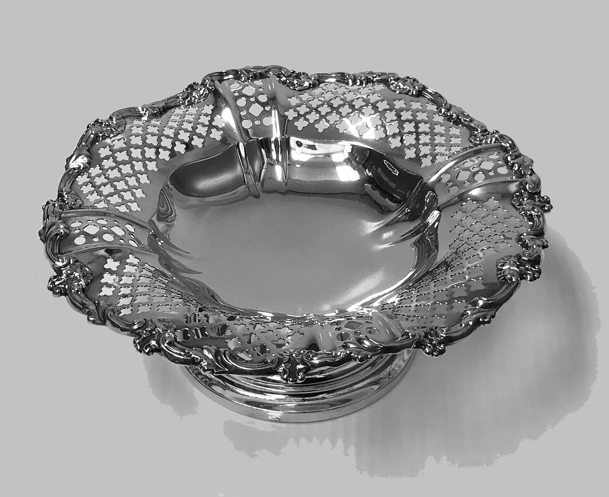 Gorham sterling compote bowl on pedestal foot, Gorham date symbol mark 1908. The undulating shaped bowl with solid plain interior base, elaborately pierced flared shaped sides, everted solid scroll and foliate shaped rim. Measures: Diameter 8