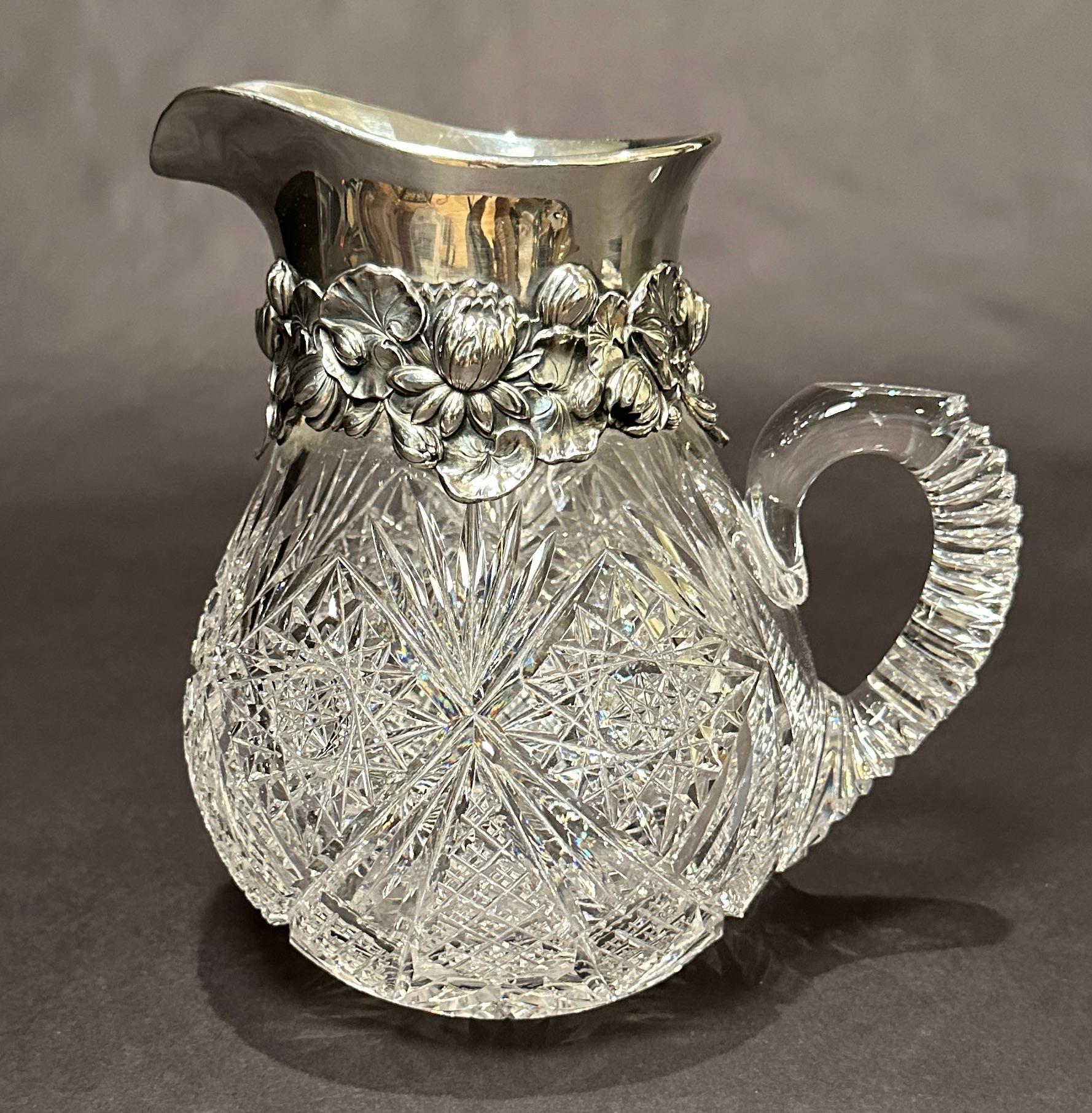 American Brilliant Cut Glass Pitcher, late 19th c., possibly C. Dorflinger and Sons, hobstar, diamond and fan pattern with Gorham sterling silver mounts in water lily motif. Period monogram under lip. Fully hallmarked.