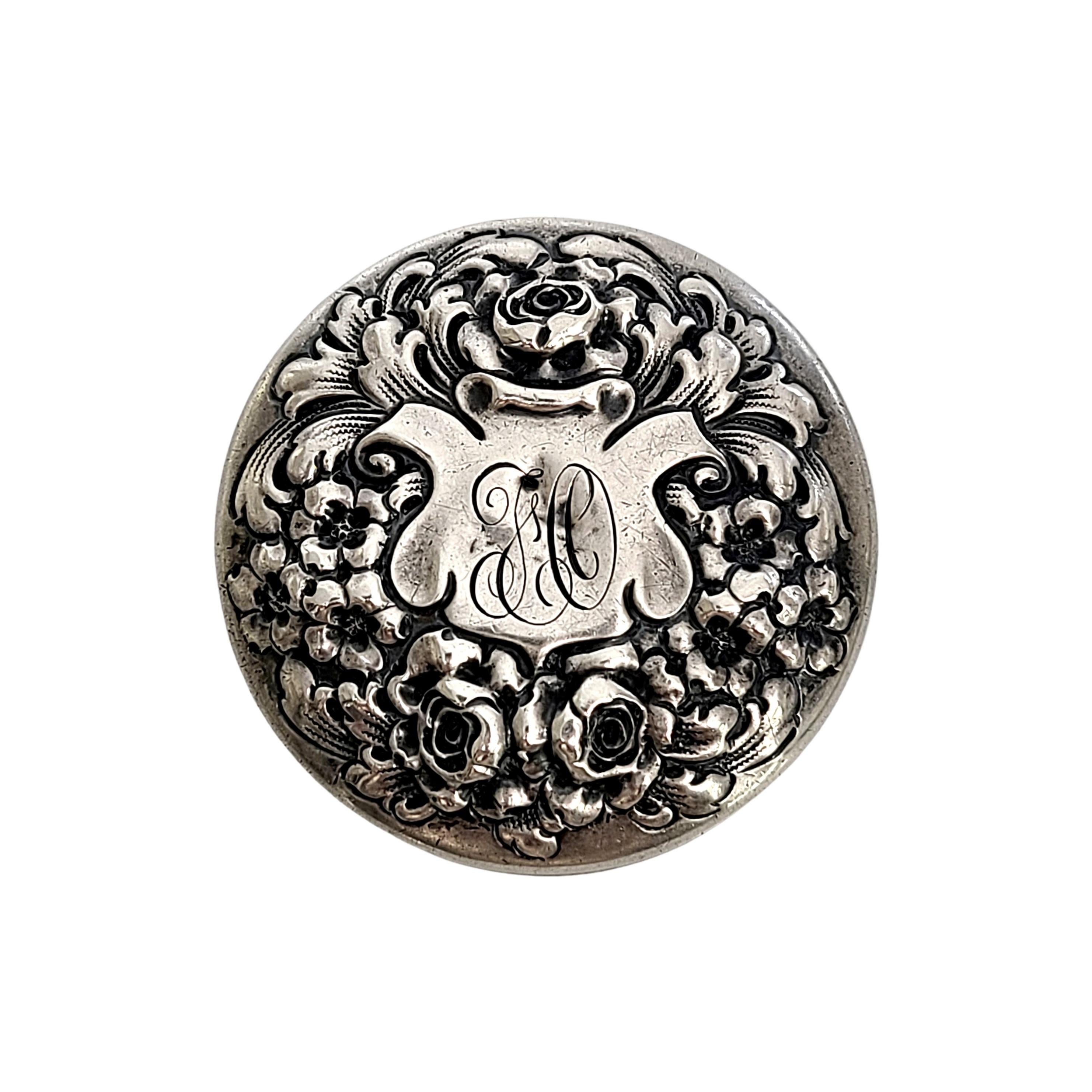 Sterling silver round pill box by Gorham, pattern # 1428M.

Monogram appears to be J&C

This sterling silver pill box features a repousse flower and flourish lid with a monogram at the center in a badge shaped cartouche.

Measures 1 7/8