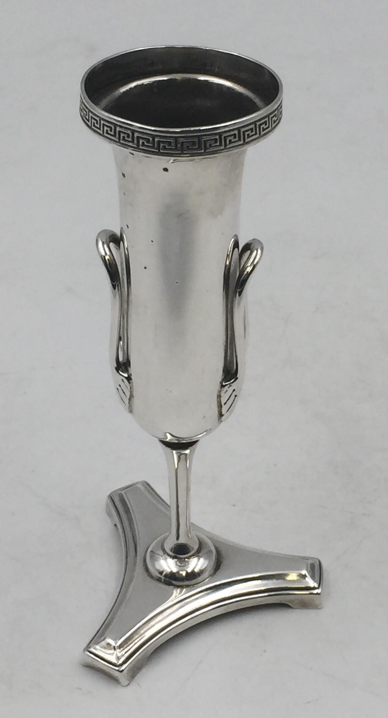 Gorham sterling silver bud vase in pattern 440 from the 1850s to mid-1860s in Neoclassical style with classical, frieze-like motifs on top, two applied decorative handles on the body, standing on a trilobed base. It measures 5 7/8'' in height by 2