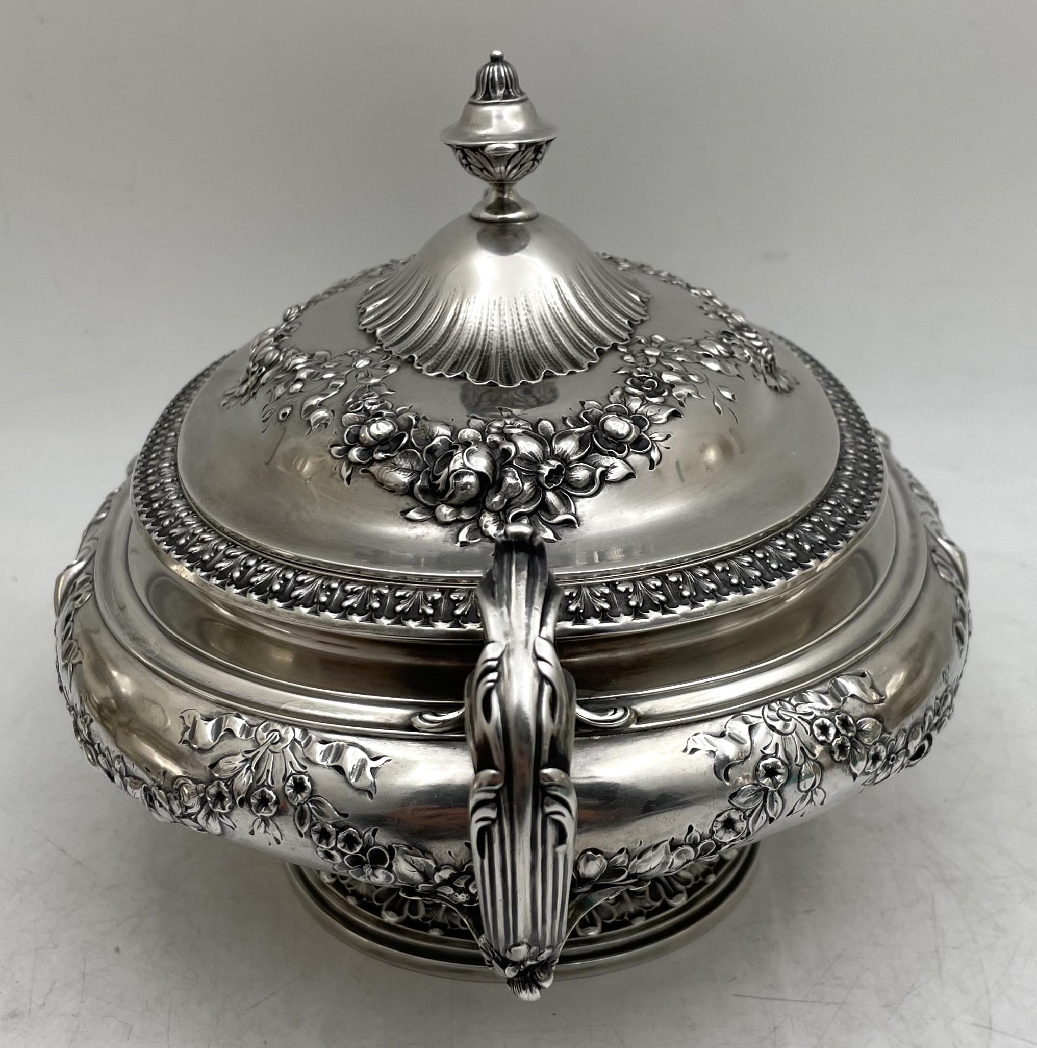 Gorham sterling silver two-handled tureen or covered bowl from 1898 and in Art Nouveau style, beautifully adorned with flowing flowers, bows, and other stylized motifs. It measures 11 1/3'' from handle to handle by 7 1/4'' in depth by 7'' in height