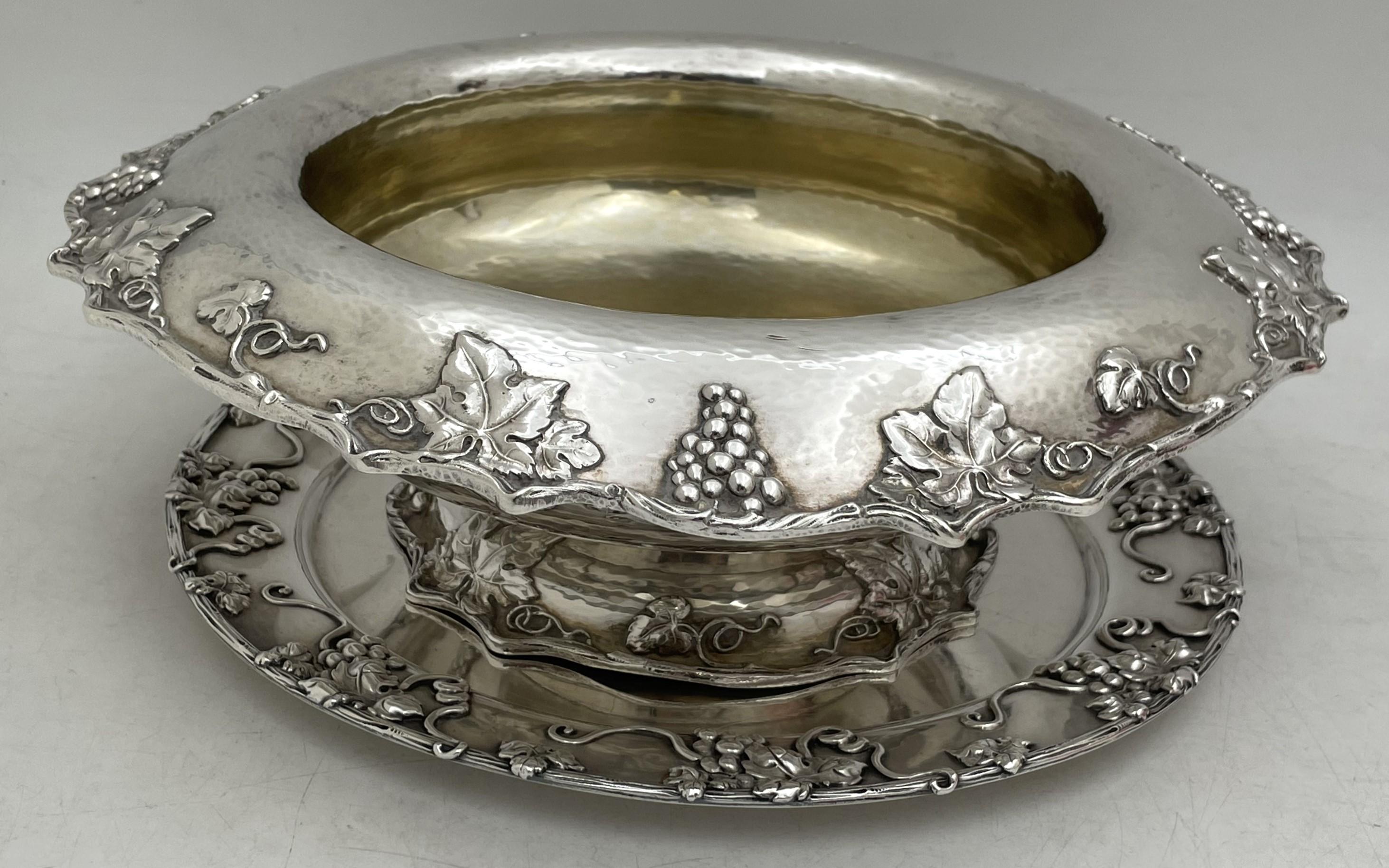 Gorham hand hammered sterling silver centerpiece bowl from 1912, gilt inside, in exquisite Art Nouveau style adorned with raised grape and vine motifs. It measures 12 1/2'' in diameter by 4 1/8'' in height. It is accompanied by a matching Theodore