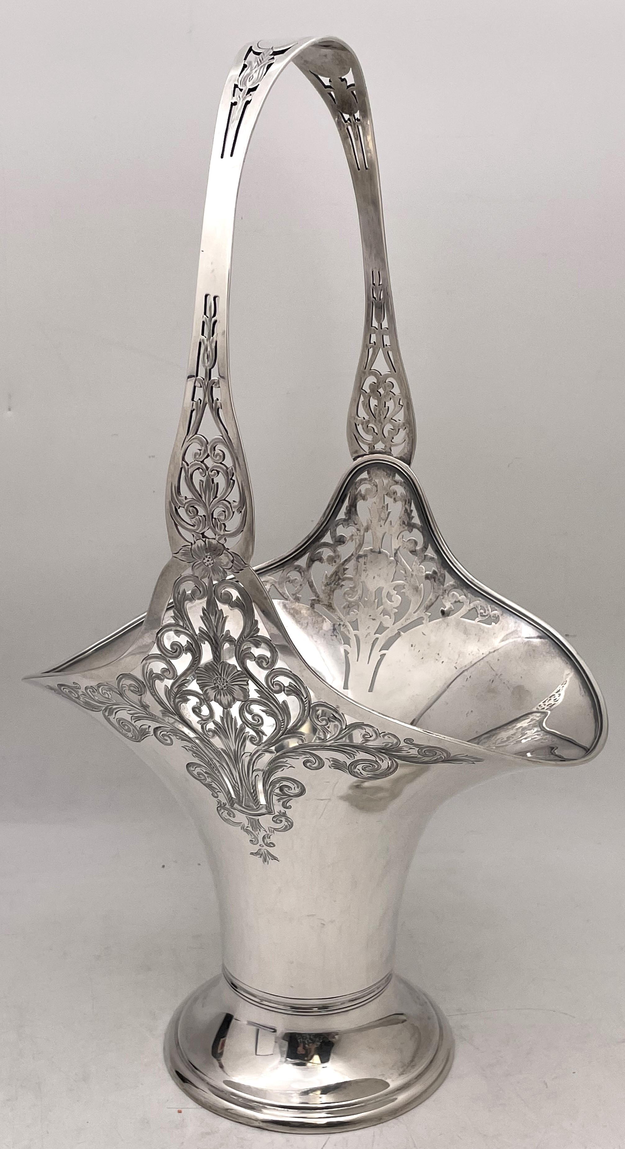 Gorham sterling silver basket or bowl in pattern number 2340A from 1915 in Art Nouveau style with pierced and finely engraved floral and natural motifs adorning the body and handle. The basket measures 17 1/2'' in height by 10'' in depth by 5 1/4''