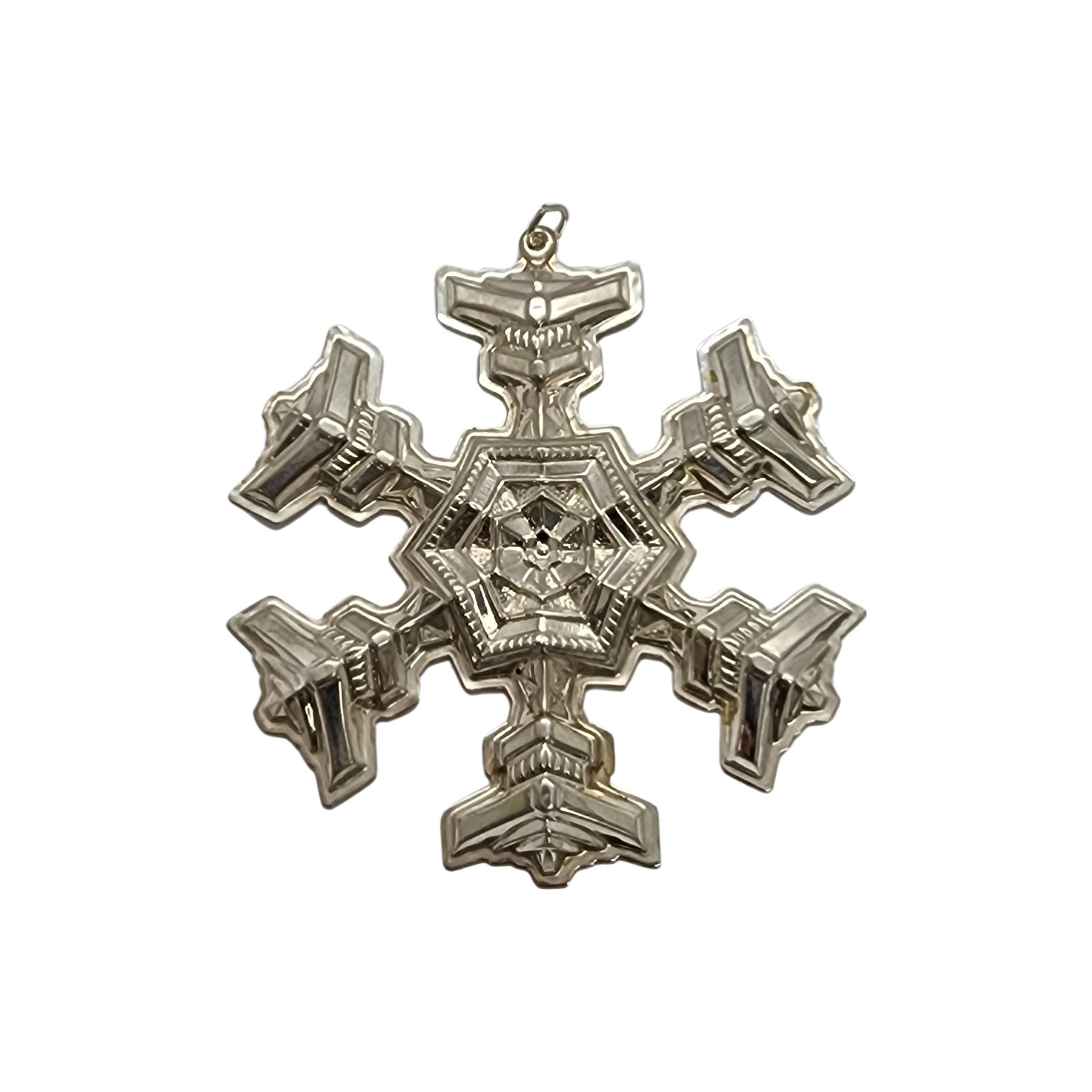 Gorham sterling silver snowflake ornament from 1977 with box and pouch.

Since 1970, Gorham has been celebrating the season with a yearly version of the classic snowflake form, creating a beautiful tradition of sparkling art. Includes original