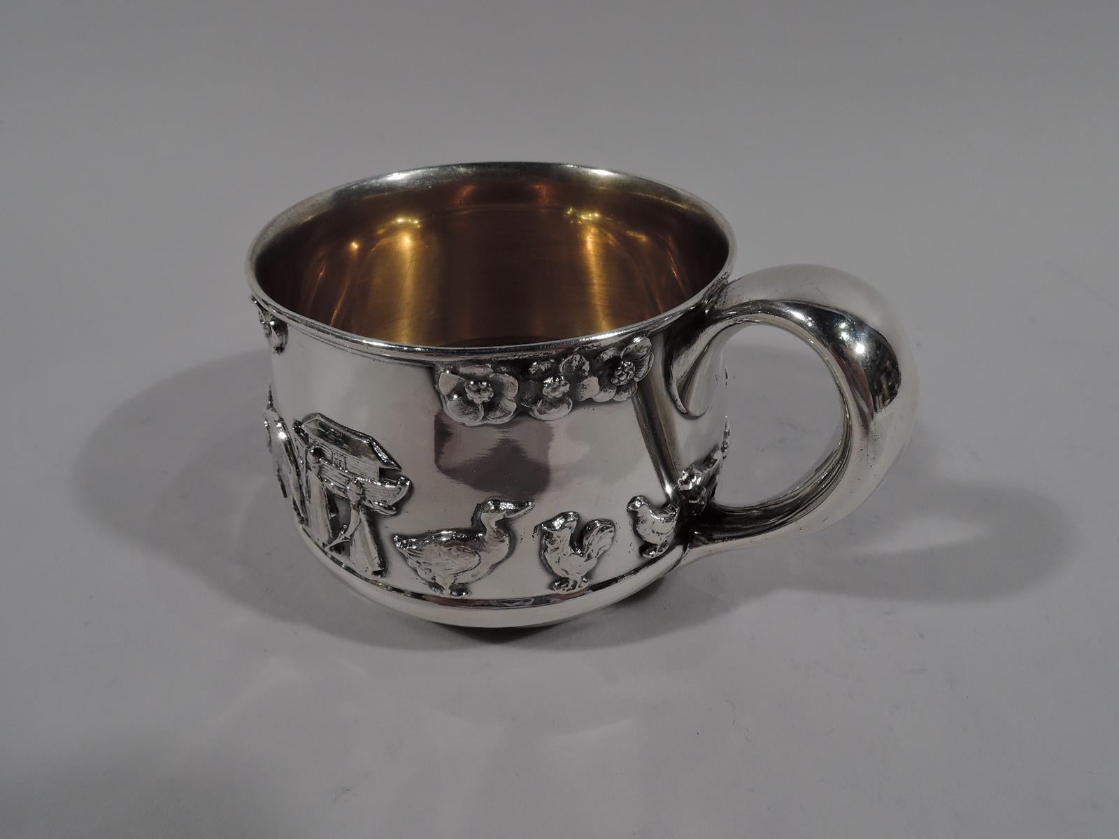 Art Deco sterling silver baby cup with Noah’s Ark motif. Made by Gorham in Providence, circa 1920. Gently curved bowl with wide and tapering -scroll handle and inset integral foot. Interior gilt washed. Applied frieze of animals marching in