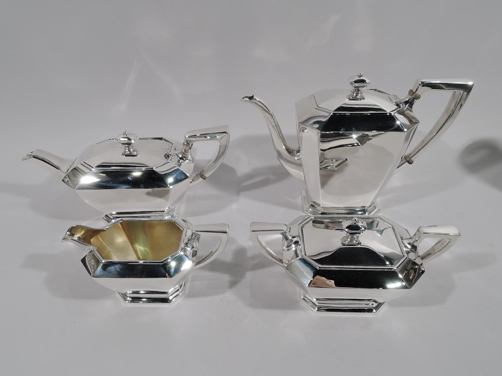 Art Deco sterling silver coffee and tea set in Fairfax. Made by Gorham in Providence in 1964-1965. This set comprises coffeepot, teapot, creamer, and sugar.

Each: Straight and tapering body with chamfered corners, on straight and chamfered raised