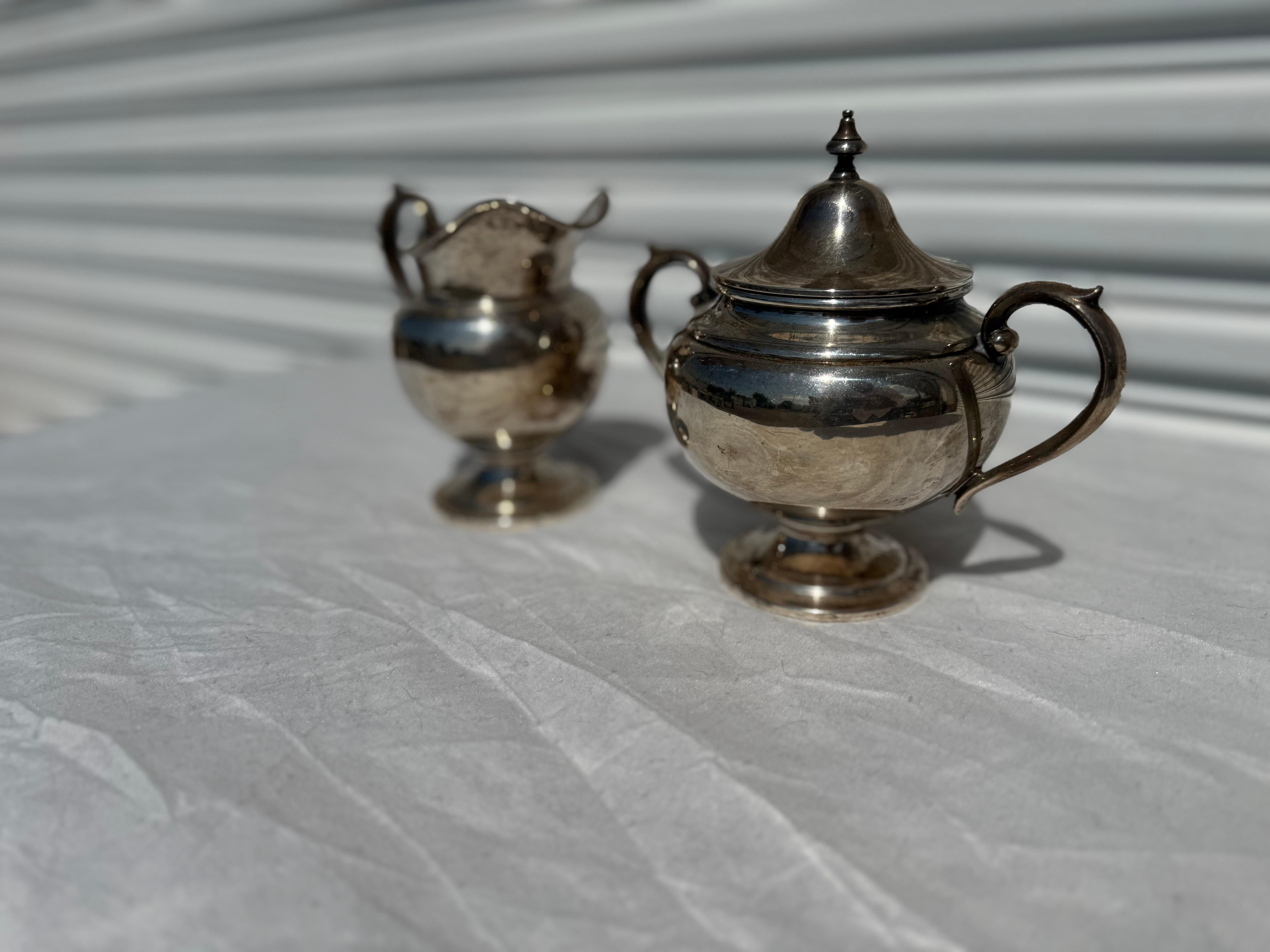 This is a creamer and sugar bowl set by Gorham Silver..
The sugar bowl and creamer are stamped Sterling.

