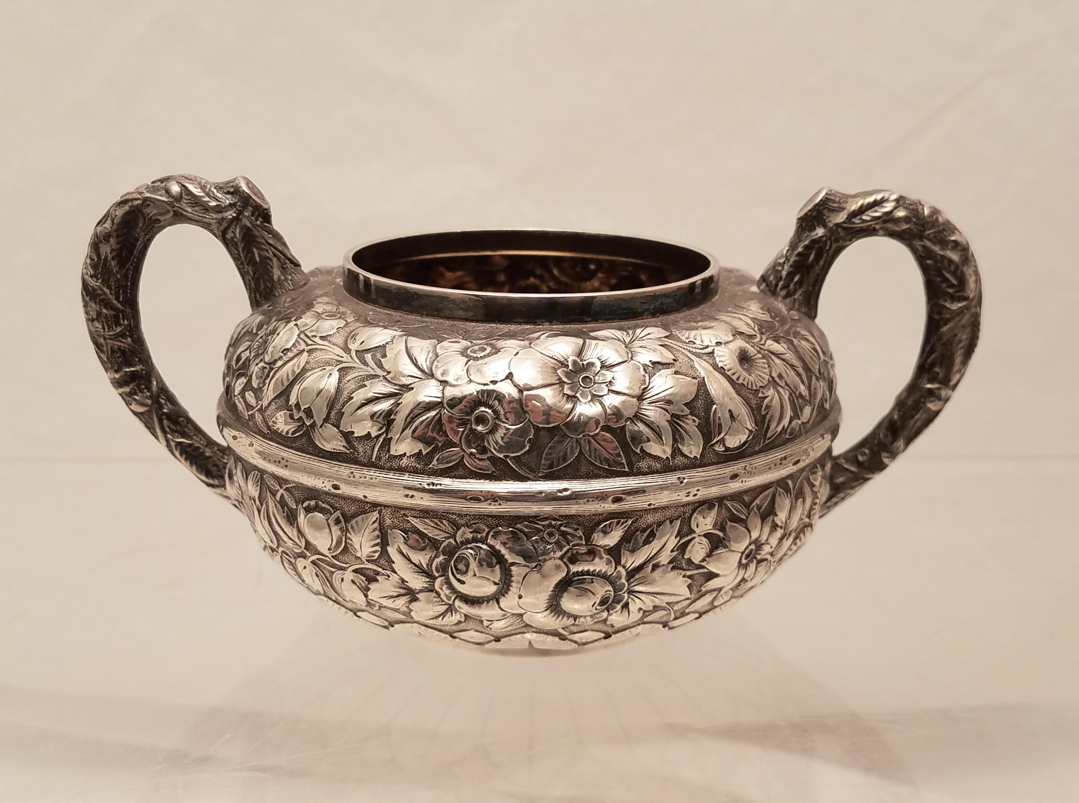 Gorham sterling silver open sugar and creamer in repousse design with handles from 1880. Open sugar measures 5.9 inches wide and 2.8 inches tall. Creamer measures 4.9 inches tall and 2.1 inches tall. Total weight 11.9 troy ounces. Bearing hallmarks