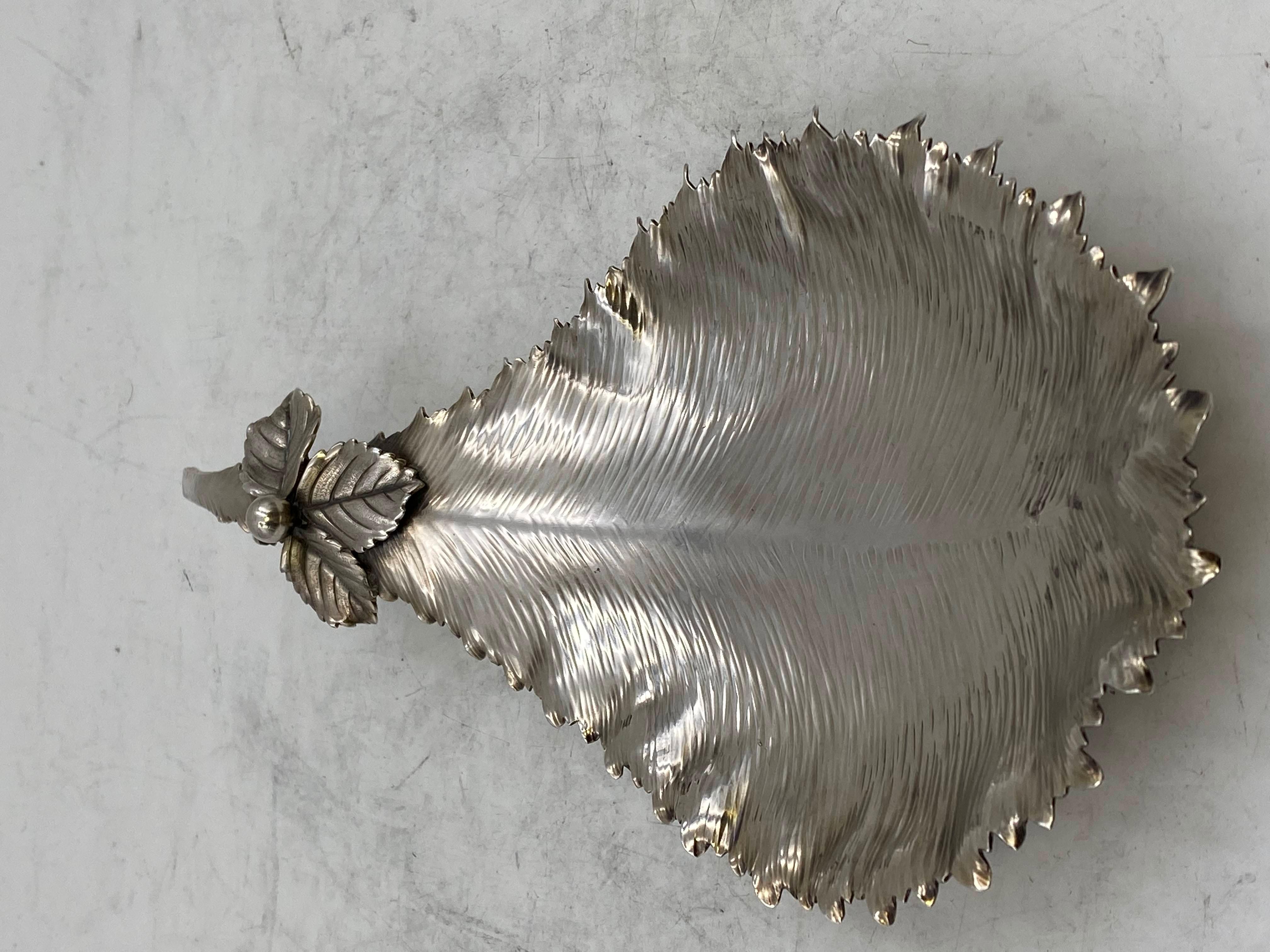 Rare sterling silver dish in leaf shape with applied leaves at the handle standing on 3 shell-shaped motifs by Gorham dating back to 1882. Measuring 10” in length, 4 ¾” in width at the largest point, and 1” in height and weighing 6 ozt. Pattern