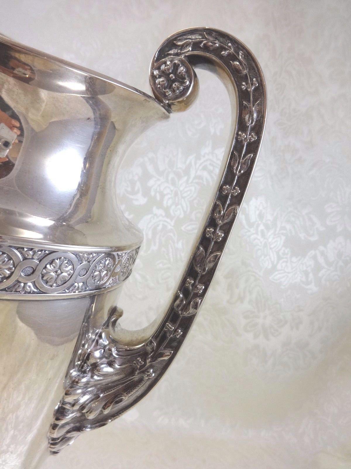 Gorham
Exceptional Gorham Grecian style monumental sterling silver water pitcher 15 tall x 9 wide and holds 6 1/2 pints. It bears the sword date mark, circa 1915. Weight - 53 troy ounces. It is monogrammed with a lovely vintage monogram PLB and is