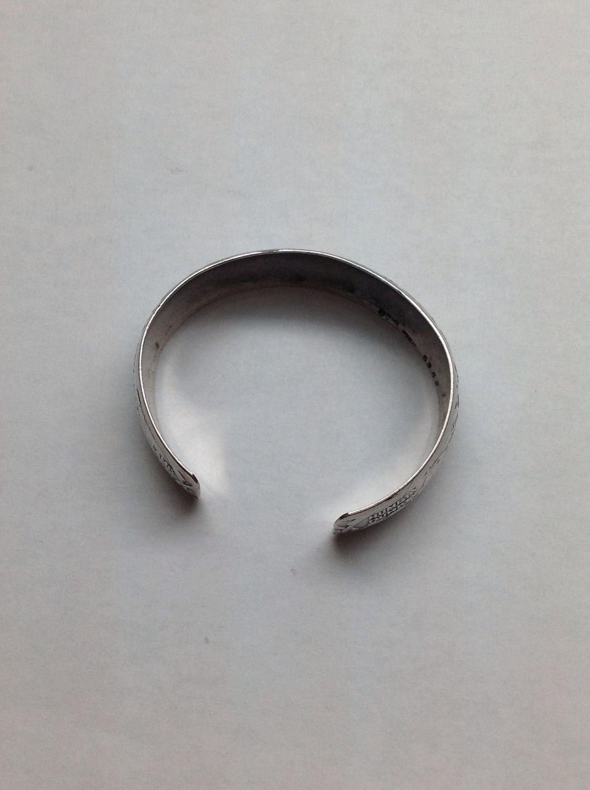 Antique Gorham nursery rhyme napkin ring made into cuff bracelet 5362.

c.1920

Marked: lion anchor G, 5362 sterling.

Measures 5 1/2