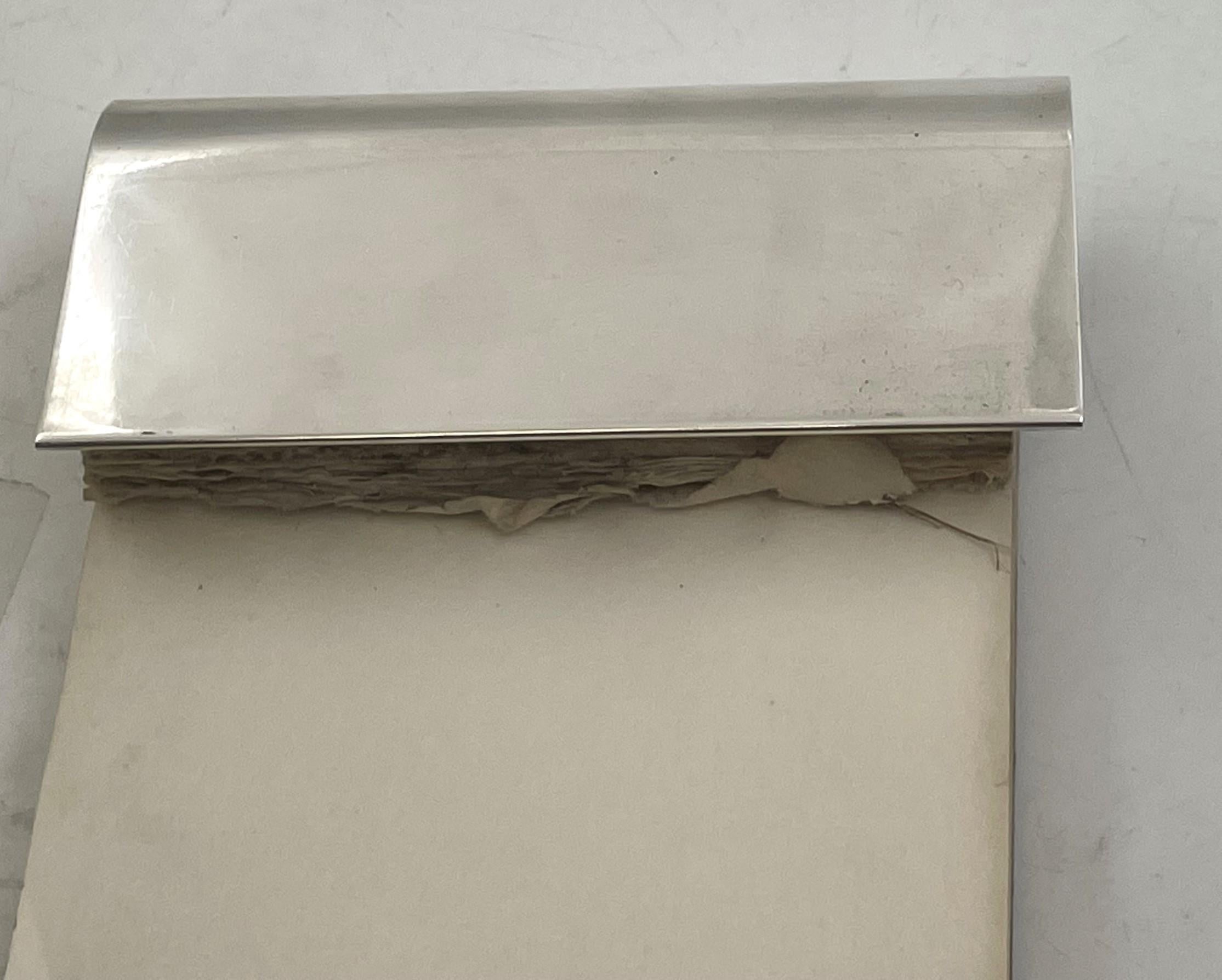 Gorham sterling silver notepad holder. It measures 3 1/2'' in width by 1 3/4'' in depth by 1'' in height, and bears hallmarks as shown.

During the heyday of American silver manufacturing–approximately 1850 to 1940–Gorham was one of the most