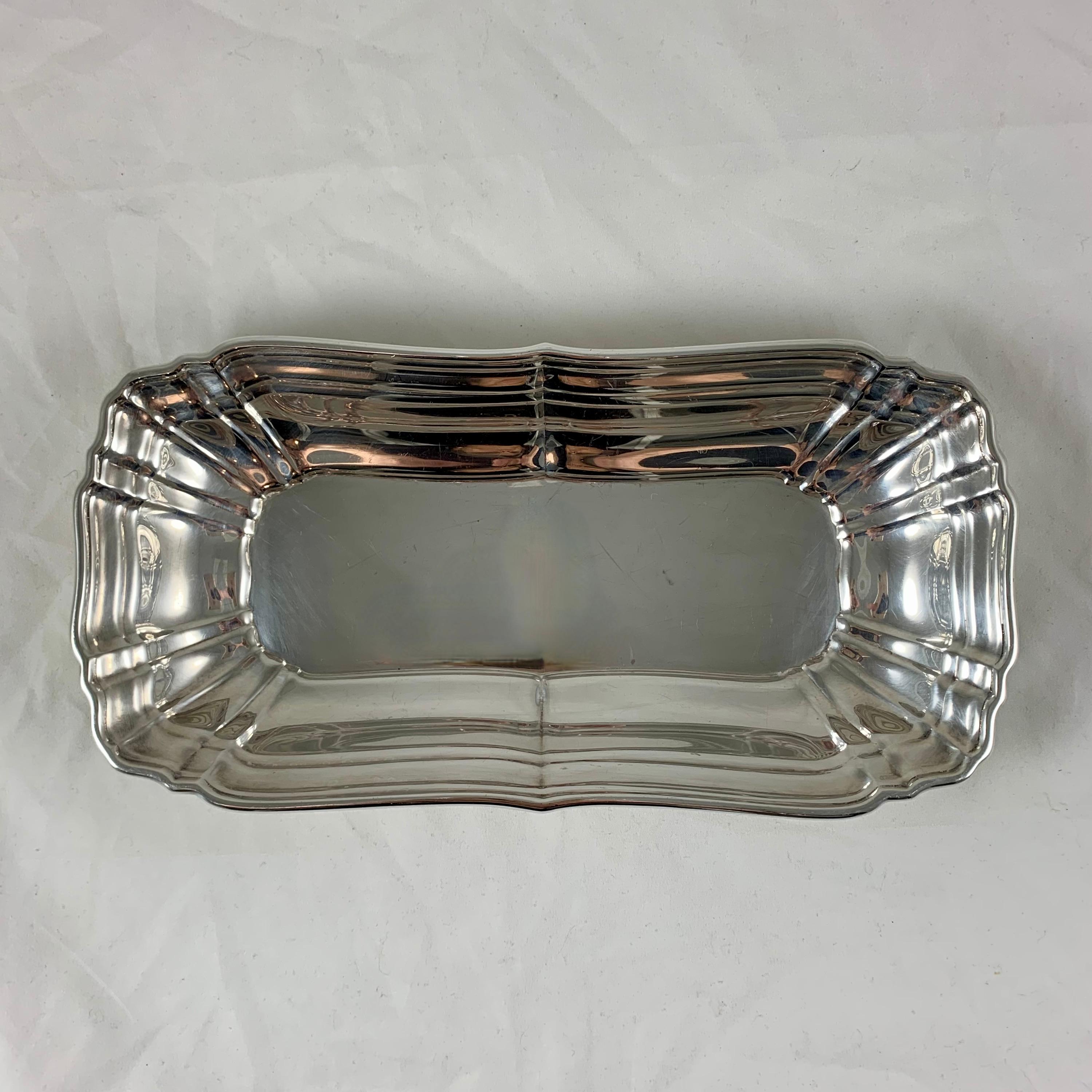 A sterling silver celery tray by Gorham, circa 1940s.
A rectangular paneled tray with a rolled, shaped rim, very heavy in weight.
Marked: Gorham Sterling 765.
Measures: 10 in. L x 5 in. W x 1 in. H
Weight: 9.138 troy ounces.
The expected