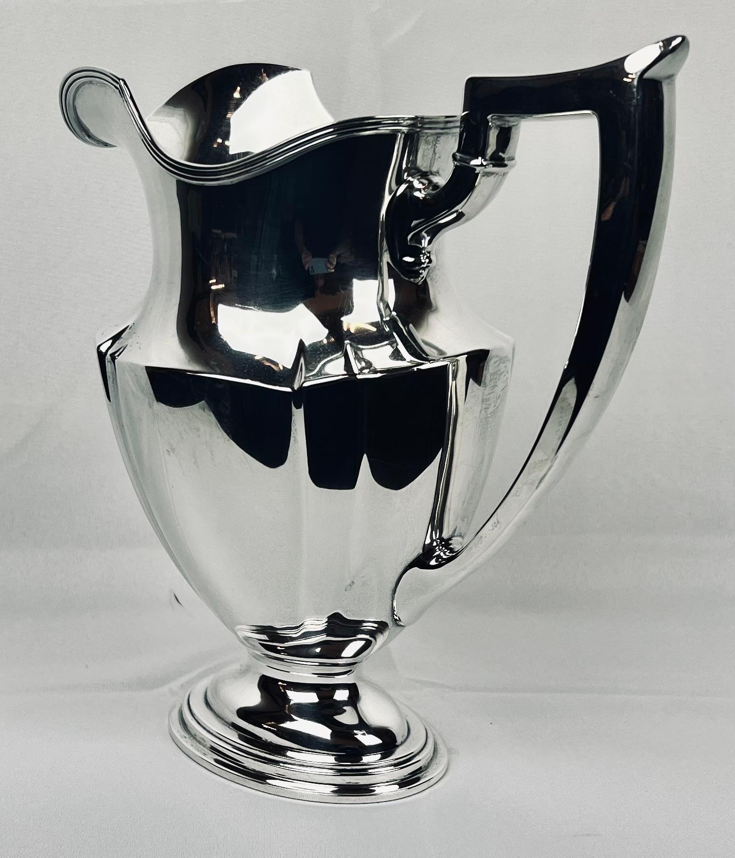 Gorham Manufacturing Company's sterling silver pitcher in the “Plymouth” pattern.  The original design was created in Providence, Rhode Island in    1909.  This pitcher is fully marked on the underside with the makers mark, the number 2788 and year