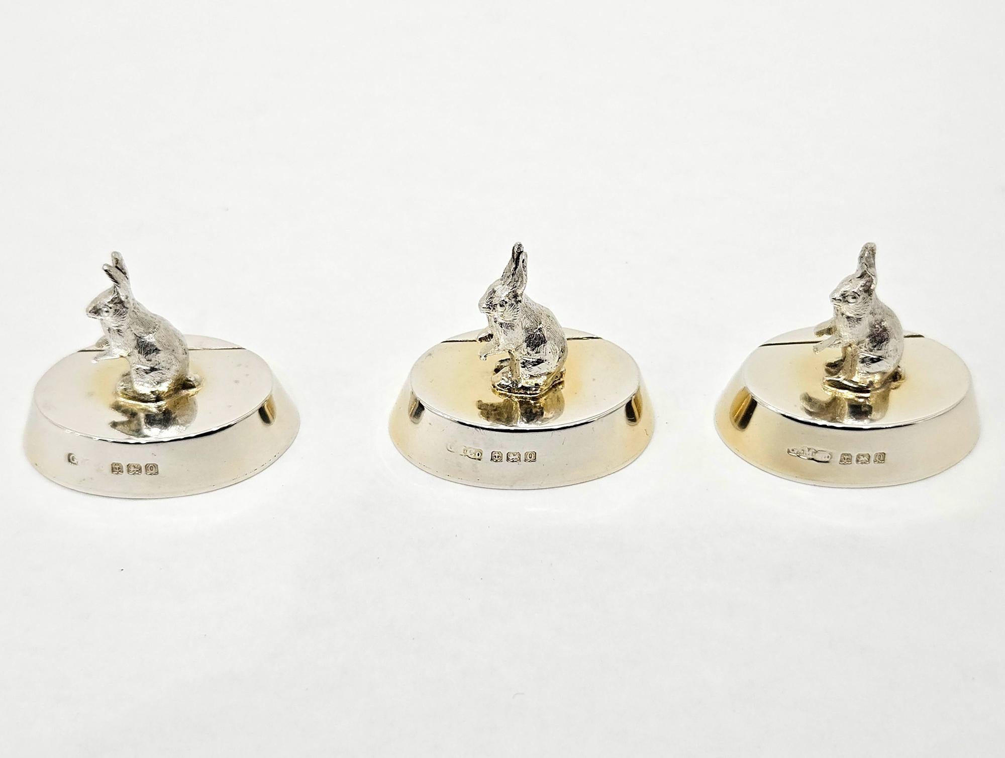 A whimsical set of three silver rabbit or hare shape menu holders made by Gorham Manufacturing Company in Birmingham, England in 1913. 

This set is very unusual and highly collectable. Each place holder has a cast model of a hare or bunny rabbit
