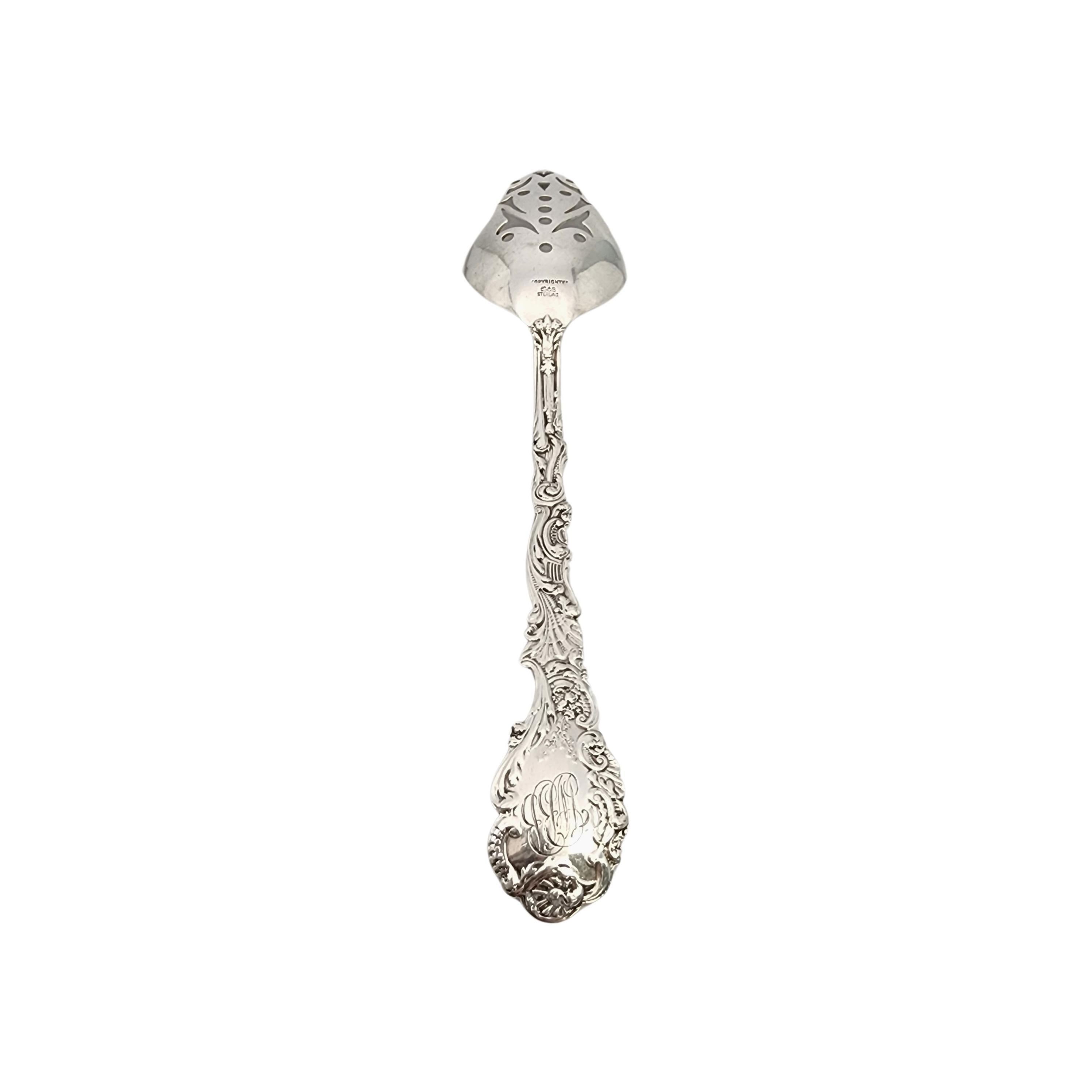 Sterling silver pierced serving tablespoon in the Versailles pattern by Gorham.

Monogram appears to be WBB (see photo).

Gorham's Versailles is a multi motif pattern designed by Antoine Heller in 1888. Named for the Palace of Versailles, the
