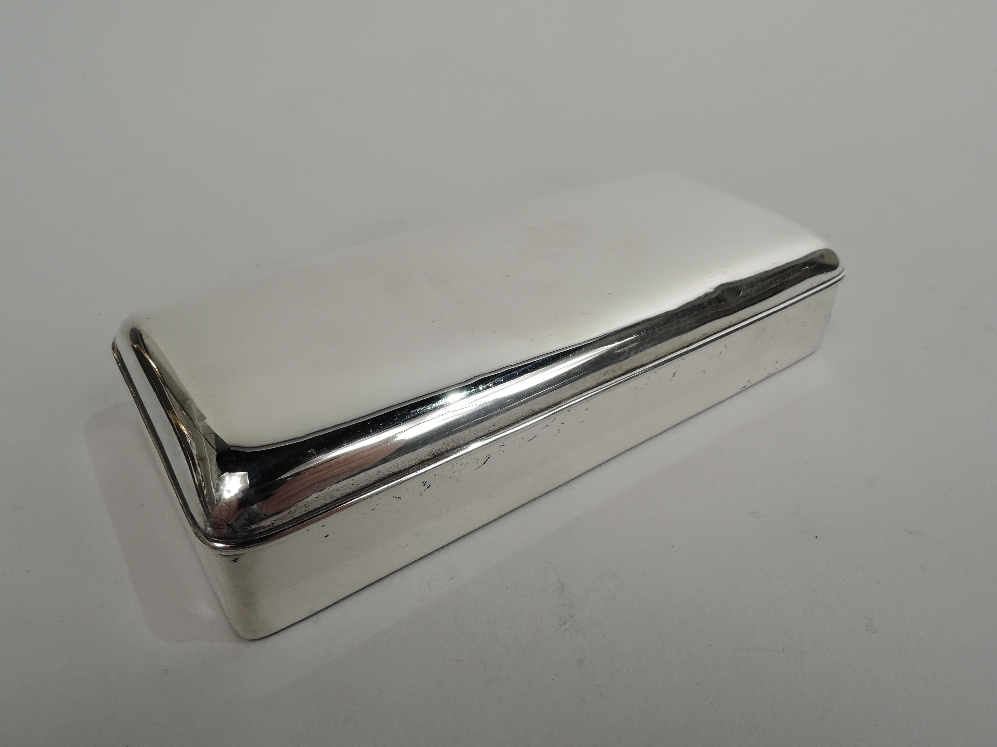 Victorian Modern sterling silver box. Made by Gorham in Providence in 1889. Rectangular with straight sides and curved corners. Cover hinged and raised. Gilt interior. Small and compact. Fully marked including maker’s stamp, date symbol, no. 265,