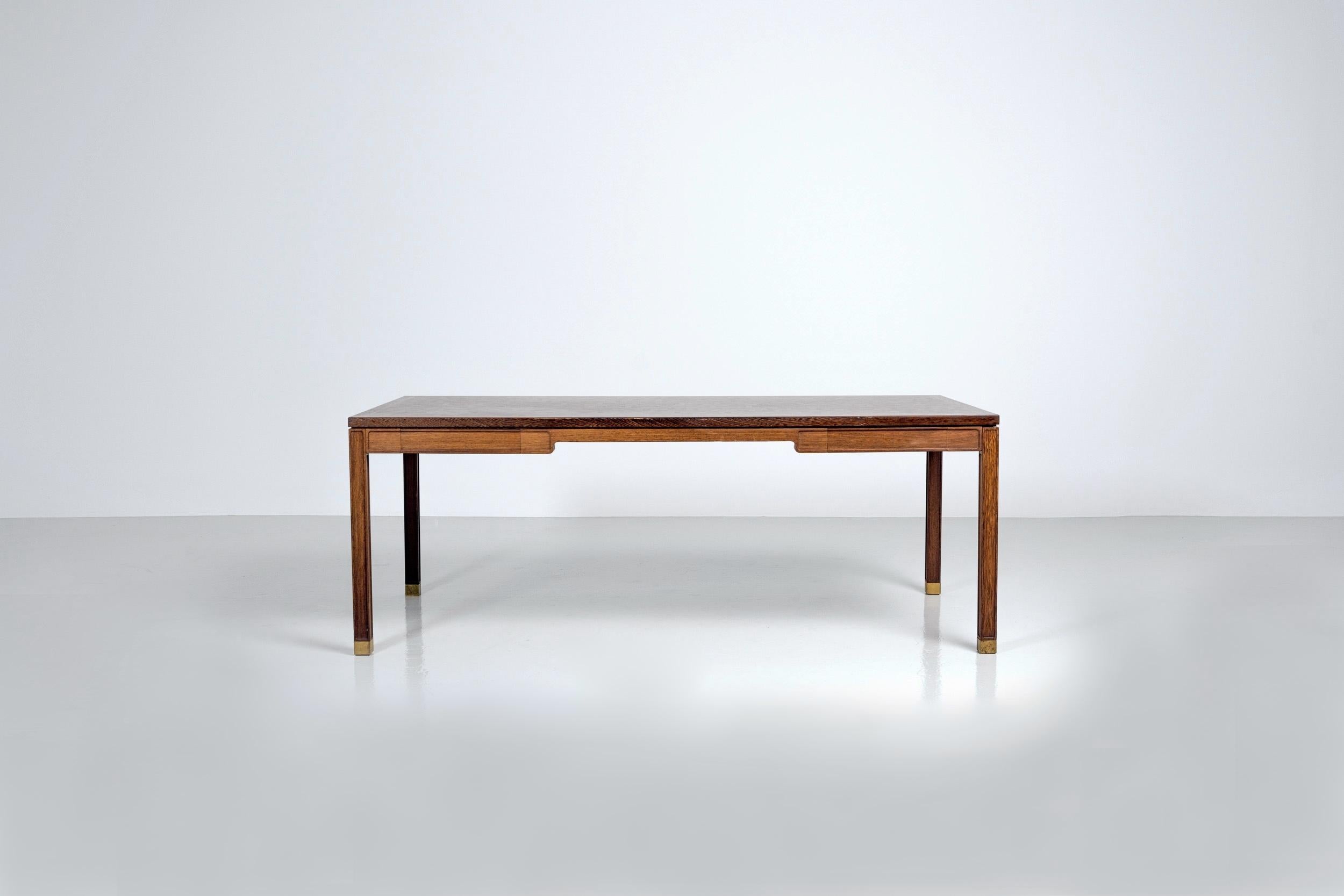 Stunning large writing desk designed by Gorm Lindrum and Rolf Middelboe and manufactured by Tranekær Furniture, Denmark 1970. The desk is made or partly solid wenge wood and partly veneer. The top is composed of several small tiles of veneer and