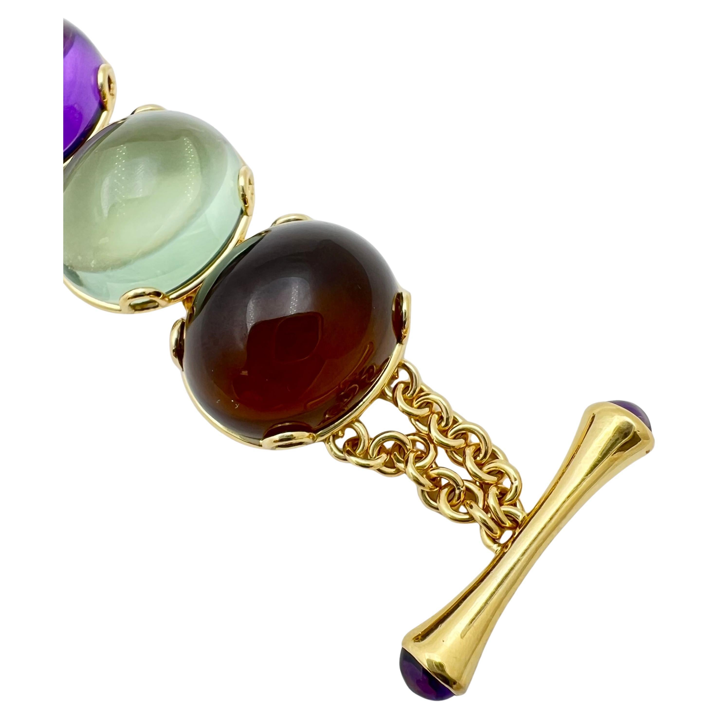 The 'Rock n Roll' multi- gemstone bracelet in 18 karat yellow gold by Goshwara.  Eight gemstones including two amethyst, London blue topaz, Swiss blue topaz, citrine quartz, prasiolite (green quartz), lemon quartz, and smokey quartz.  All cabochon