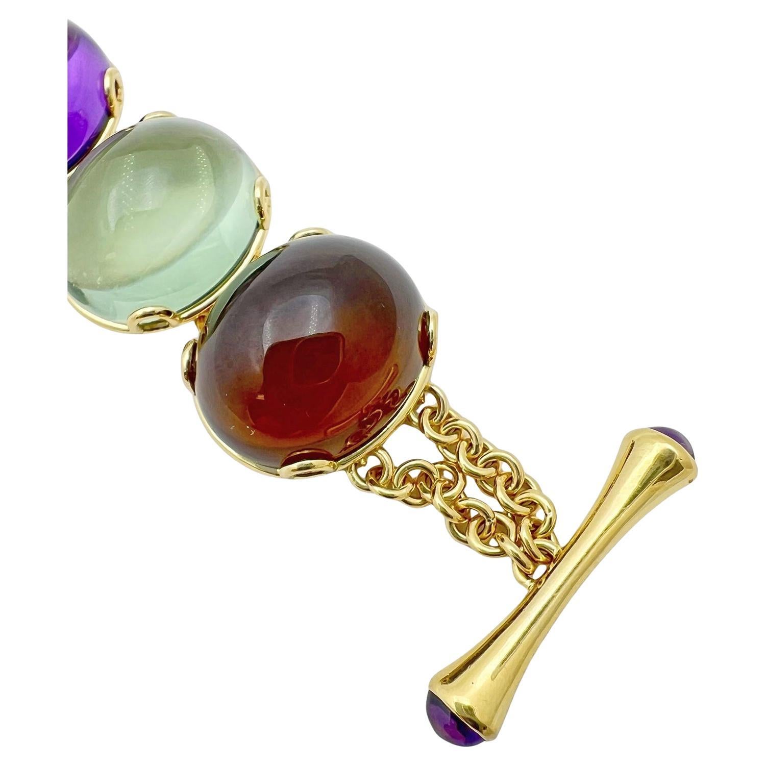 The 'Rock n Roll' multi- gemstone bracelet in 18 karat yellow gold by Goshwara.  Eight gemstones including two amethyst, London blue topaz, Swiss blue topaz, citrine quartz, prasiolite (green quartz), lemon quartz, and smokey quartz.  All cabochon