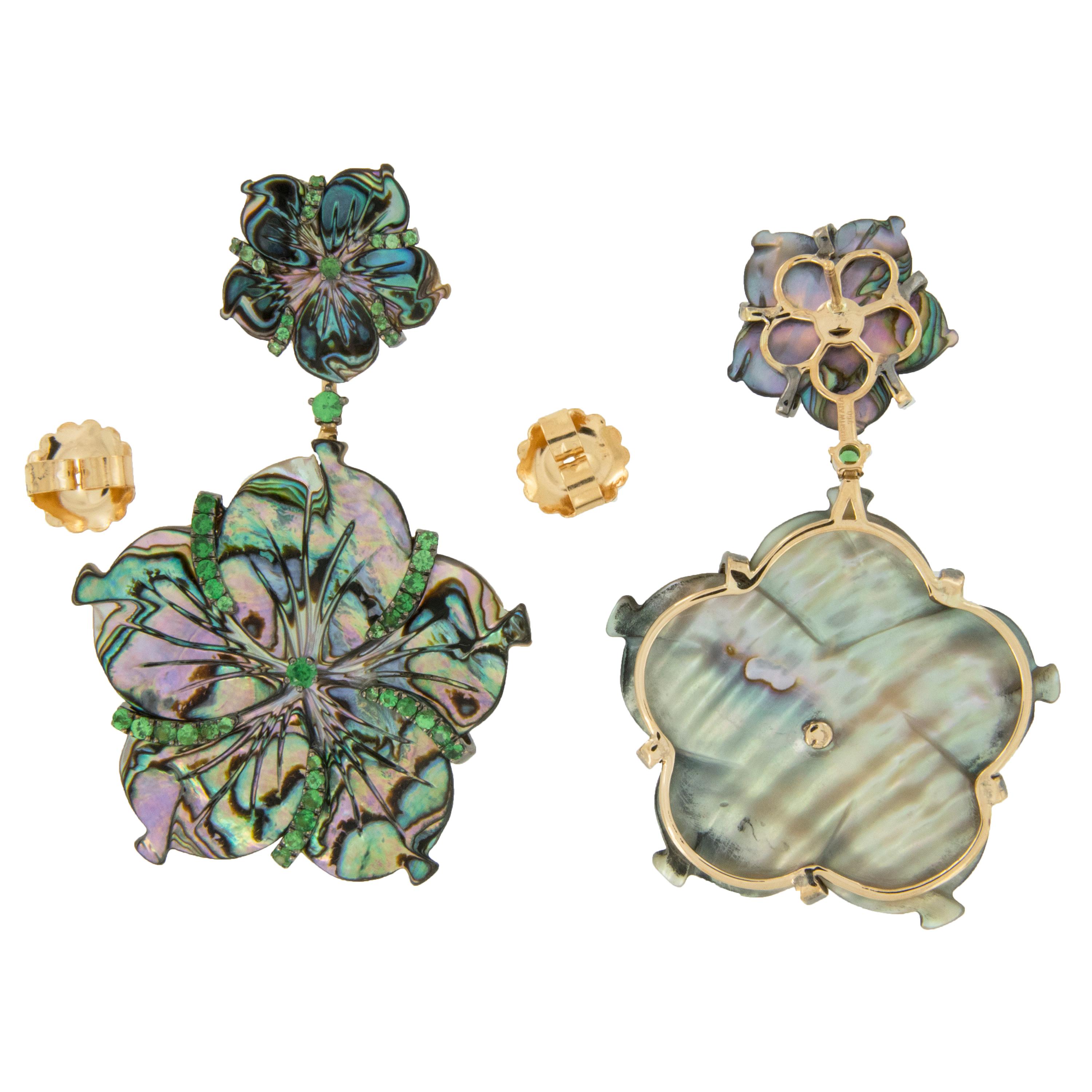 Goshwara, a term for perfect shape, is a company known for exceptional color gems and these 18 karat yellow gold carved floral earrings with carved grey mother of pearl = 31,55 Cttw & 0.78 Cttw Tsavorites is no exception! The Innate Collection uses