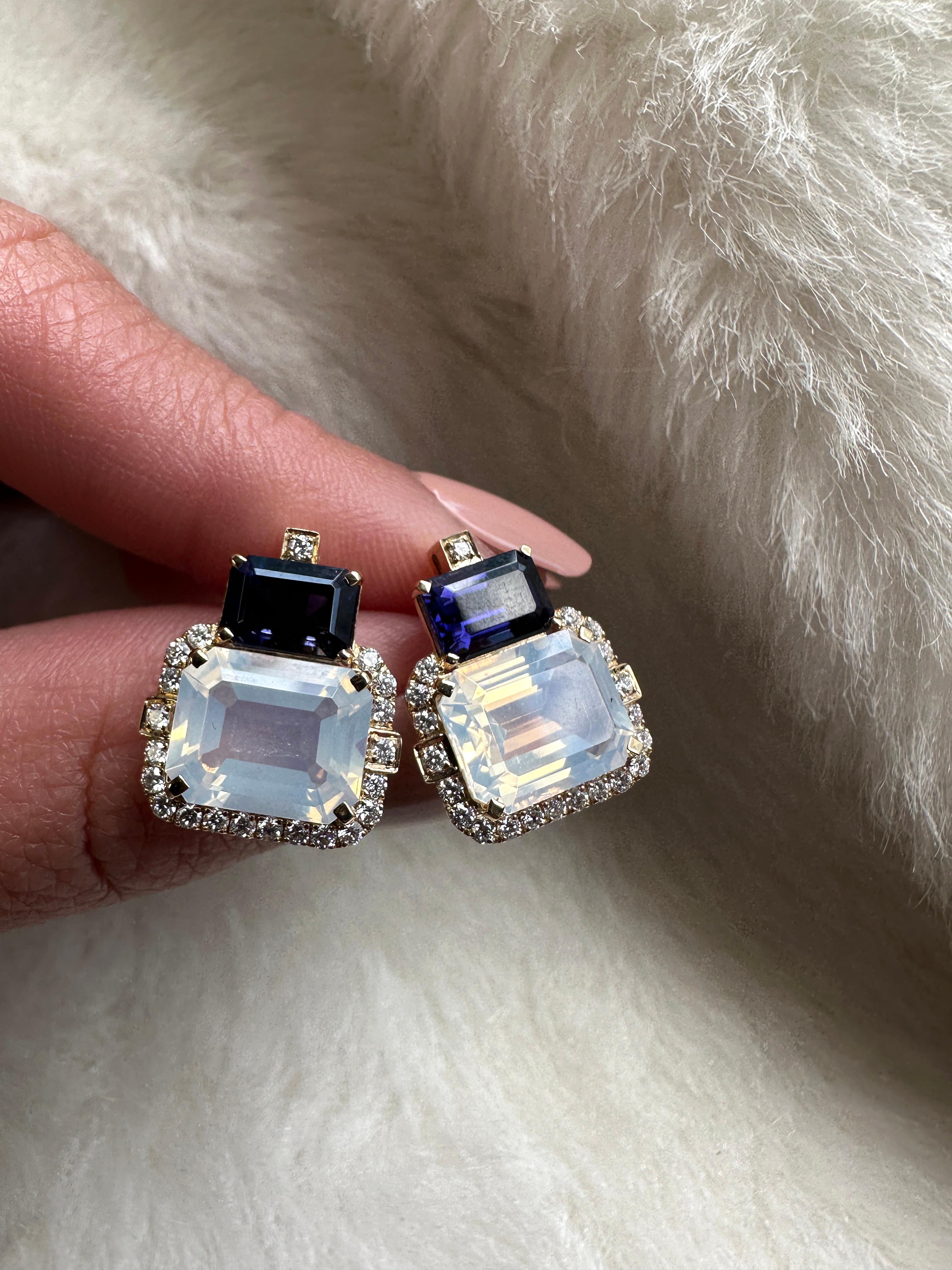 Introducing the captivating 2 Stone Iolite and Moon Quartz Emerald Cut Earrings with Diamonds in 18K Yellow Gold, a remarkable creation from the exquisite 'Gossip' Collection. Crafted with meticulous attention to detail, these earrings embody