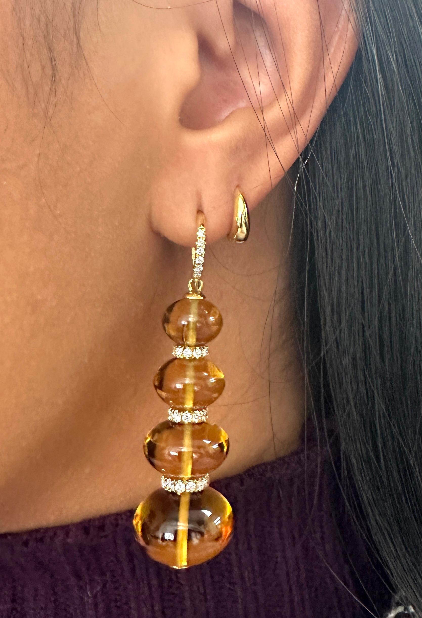 These 4 Tier Citrine Bead Earrings with Diamond Hook & Diamond Rondels in 18K Yellow Gold are a stunning piece from the 'Beyond' Collection. These earrings feature four tiers of golden citrine beads that cascade from a diamond-studded hook, adding a