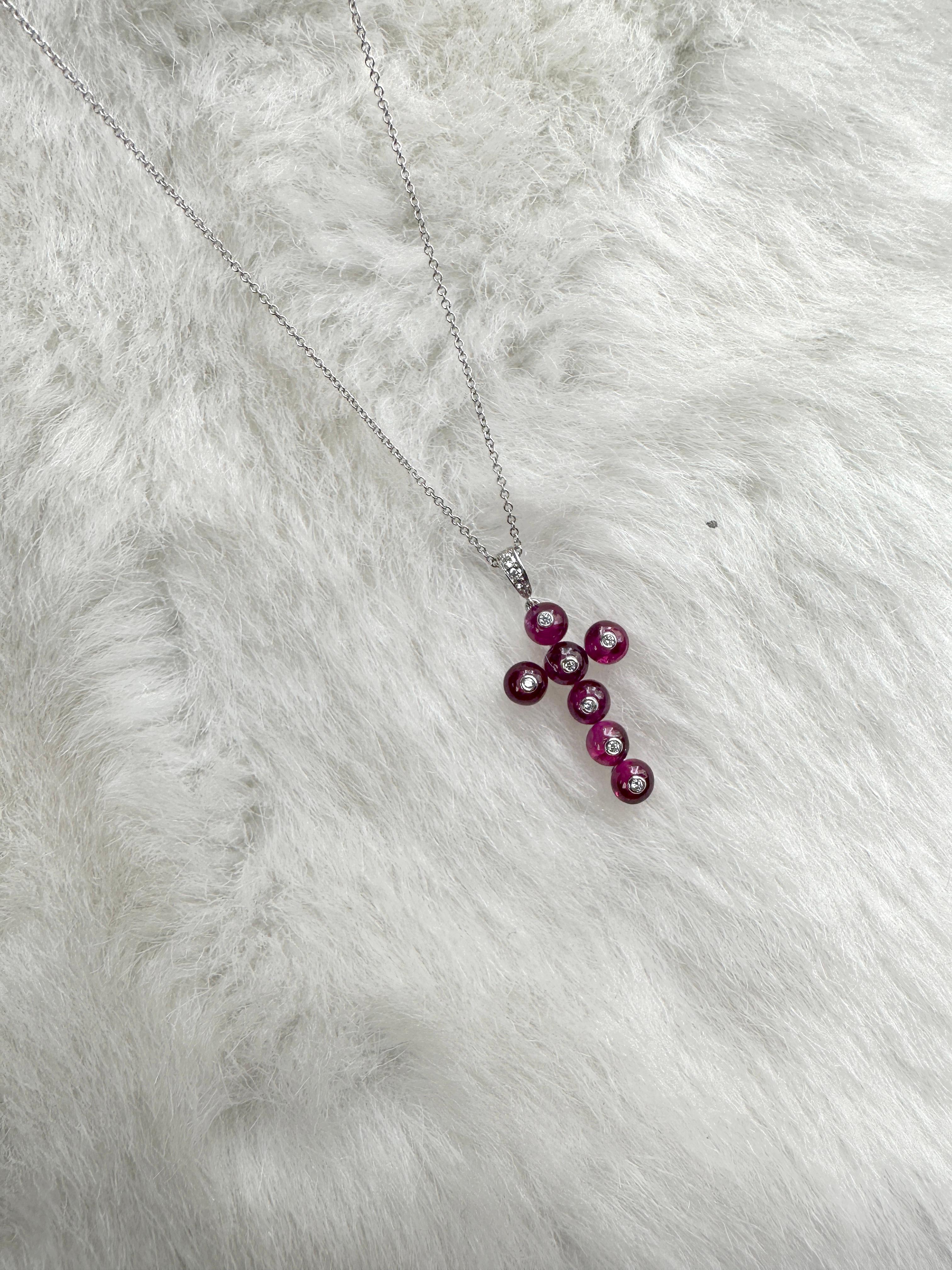 The 7 Stone Ruby Bead with Diamonds Pendant in Platinum with 18K White Gold Chain is a stunning piece of jewelry from the 'G-One' Collection. The pendant features seven exquisite rubies in a bead style, surrounded by shimmering diamonds, set in