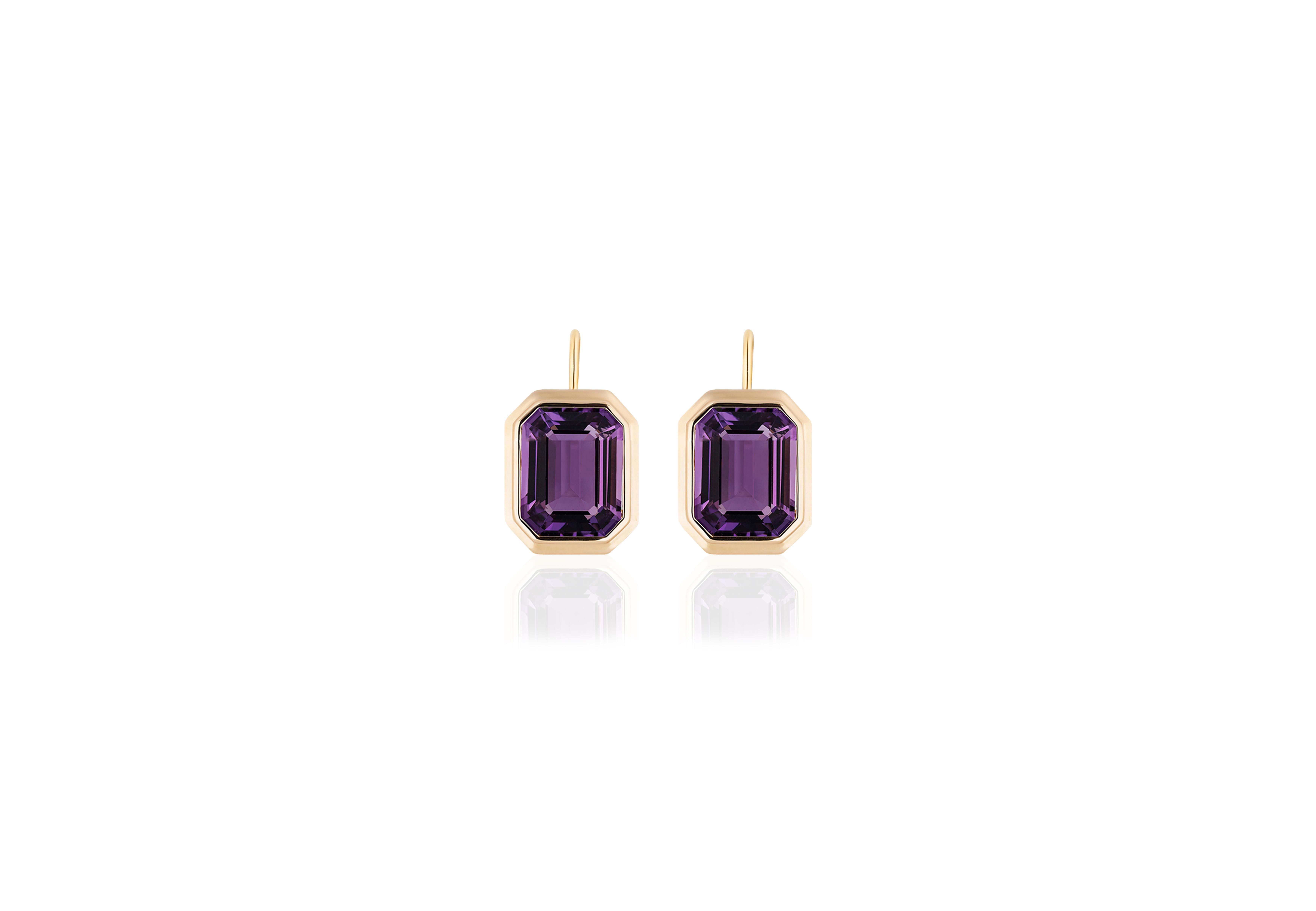 These Amethyst Emerald Cut Bezel Set Earrings on Wire in 18K Yellow Gold from the 'Manhattan Collection are a stunning and sophisticated jewelry piece. These earrings feature exquisite amethyst gemstones with an elegant emerald cut, cradled in a