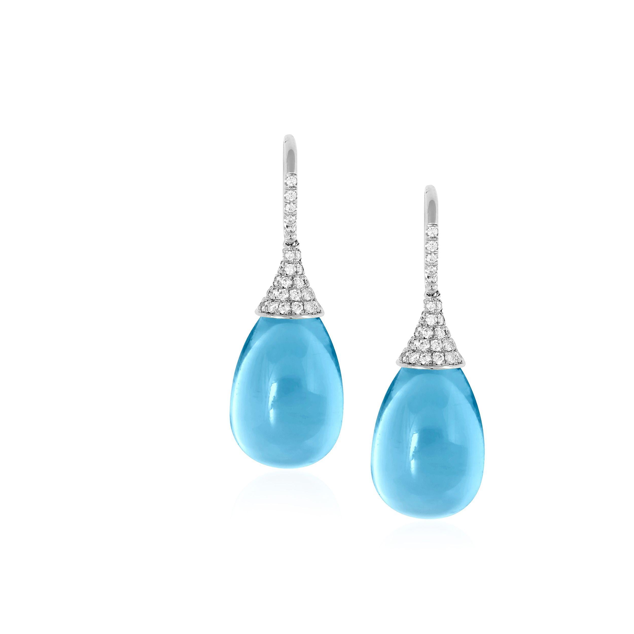 These Blue Topaz Drops Earrings with Diamonds cap in 18K White Gold, from the 'Naughty' Collection, are a stunning piece of jewelry designed for the fashion-forward and daring individual. The earrings feature blue topaz drops, held in place by a