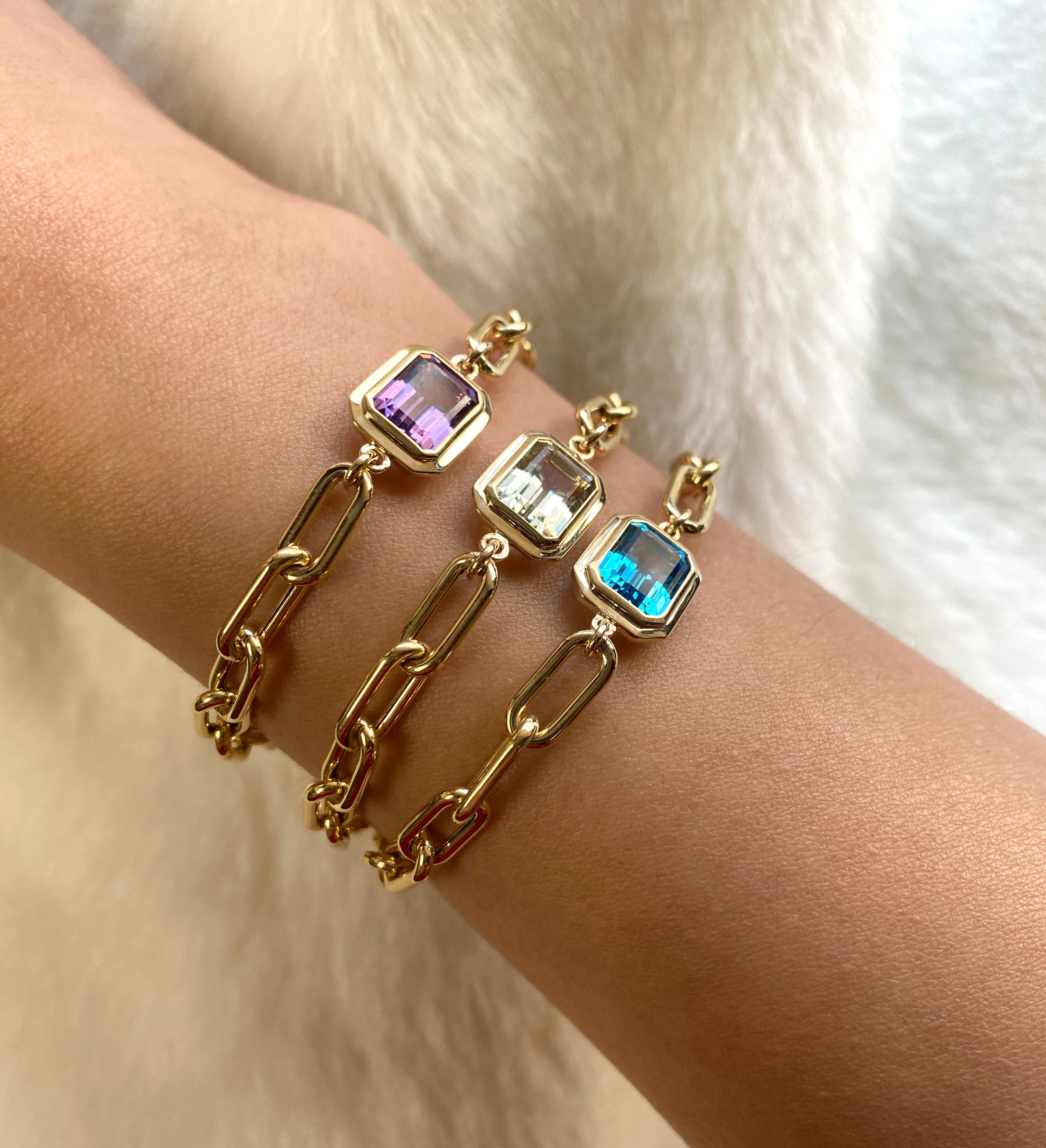 Elevate your style with the Blue Topaz Emerald Cut Bezel Set Bracelet in 18K Yellow Gold from our captivating 'Manhattan' Collection. Merging minimalist elegance with confident design, this bracelet captures the essence of New York City's iconic