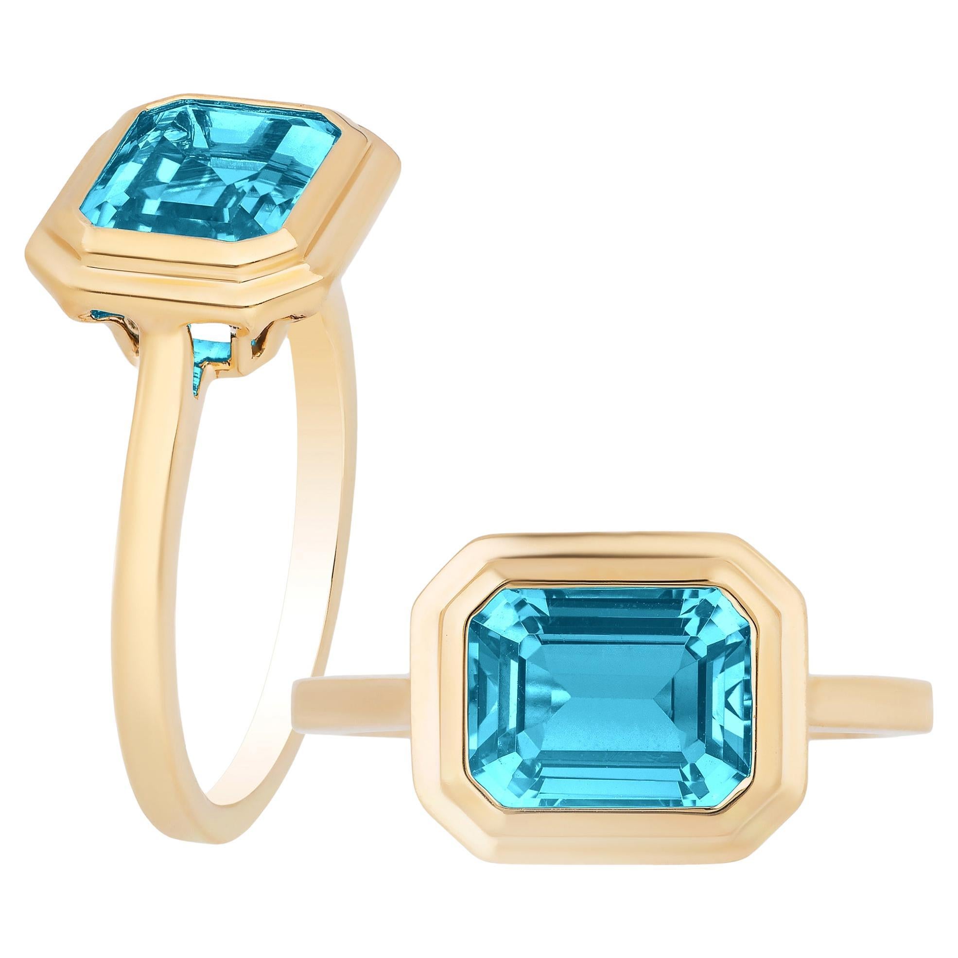 Goshwara Blue Topaz Emerald Cut Bezel Set Ring For Sale
