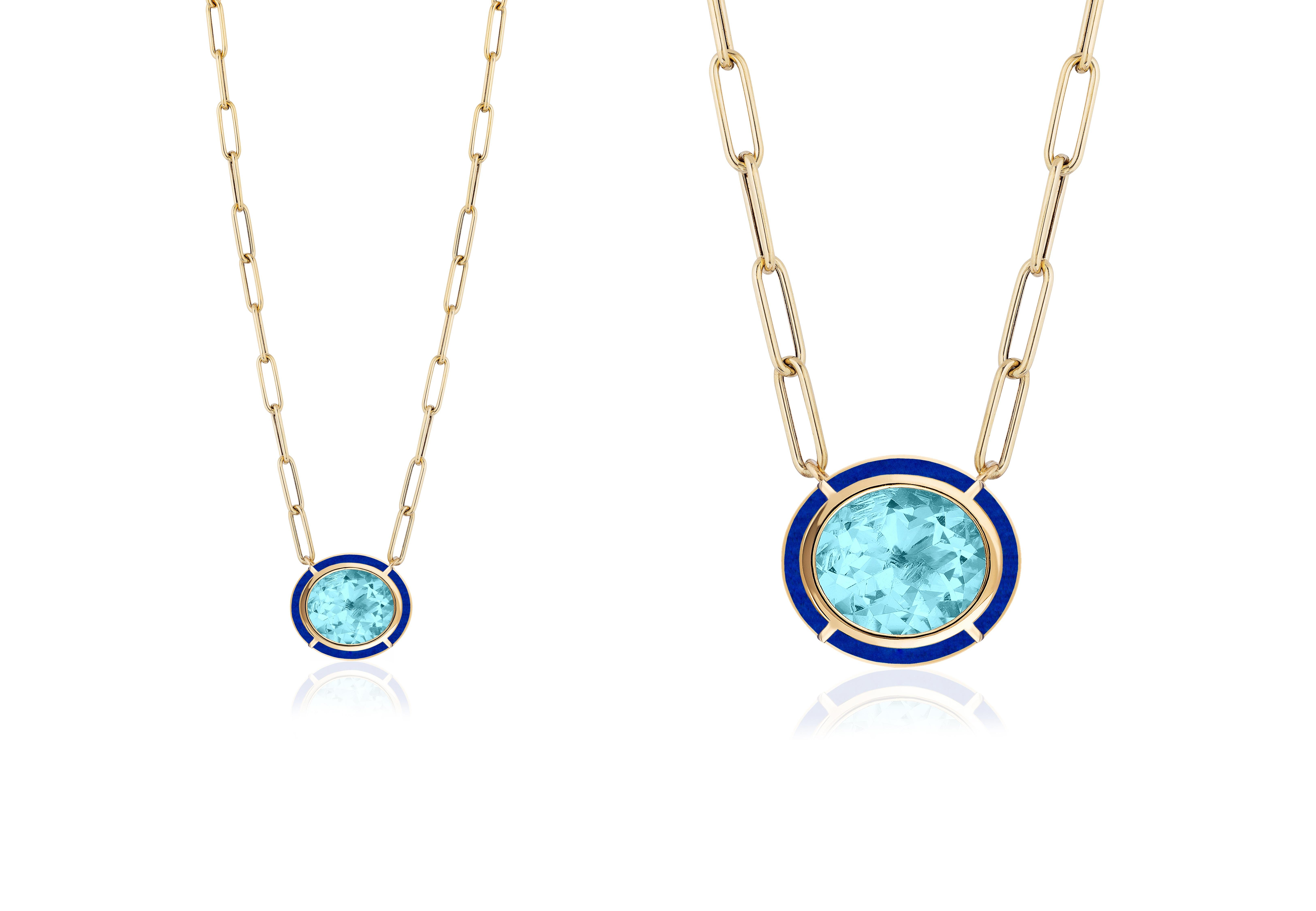 This Blue Topaz & Lapis Lazuli Inlay Oval Pendant in 18K Yellow Gold is a stunning piece of jewelry from the 'Mélange' Collection. The pendant features an oval-shaped Blue Topaz surrounded by a Lapis Lazuli stone, both set in 18K Yellow gold. The