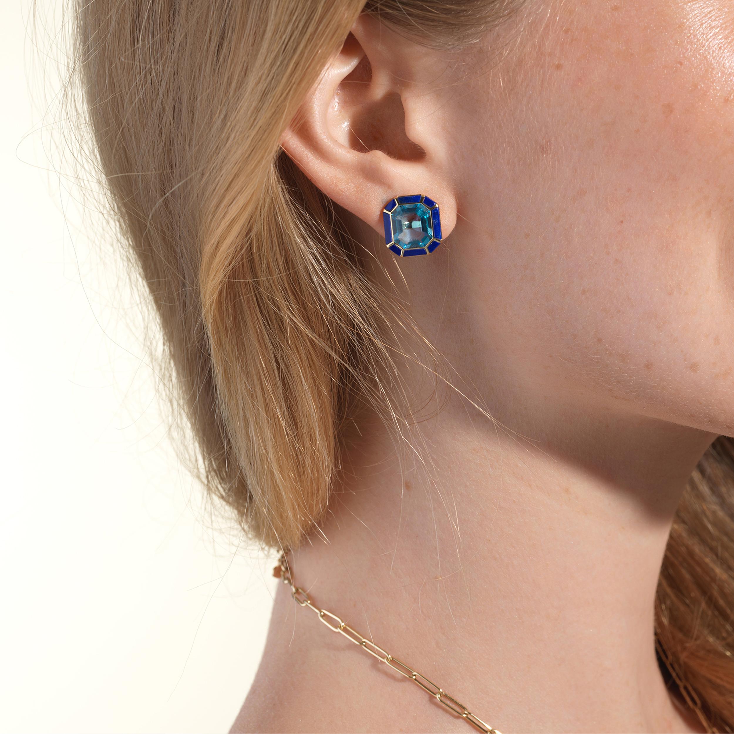 The Blue Topaz & Lapis Lazuli Stud Earrings from the 'Melange' Collection showcase a captivating blend of elegance and charm. Crafted with exquisite attention to detail, these earrings feature stunning emerald cut Blue Topaz and Lapis Lazuli