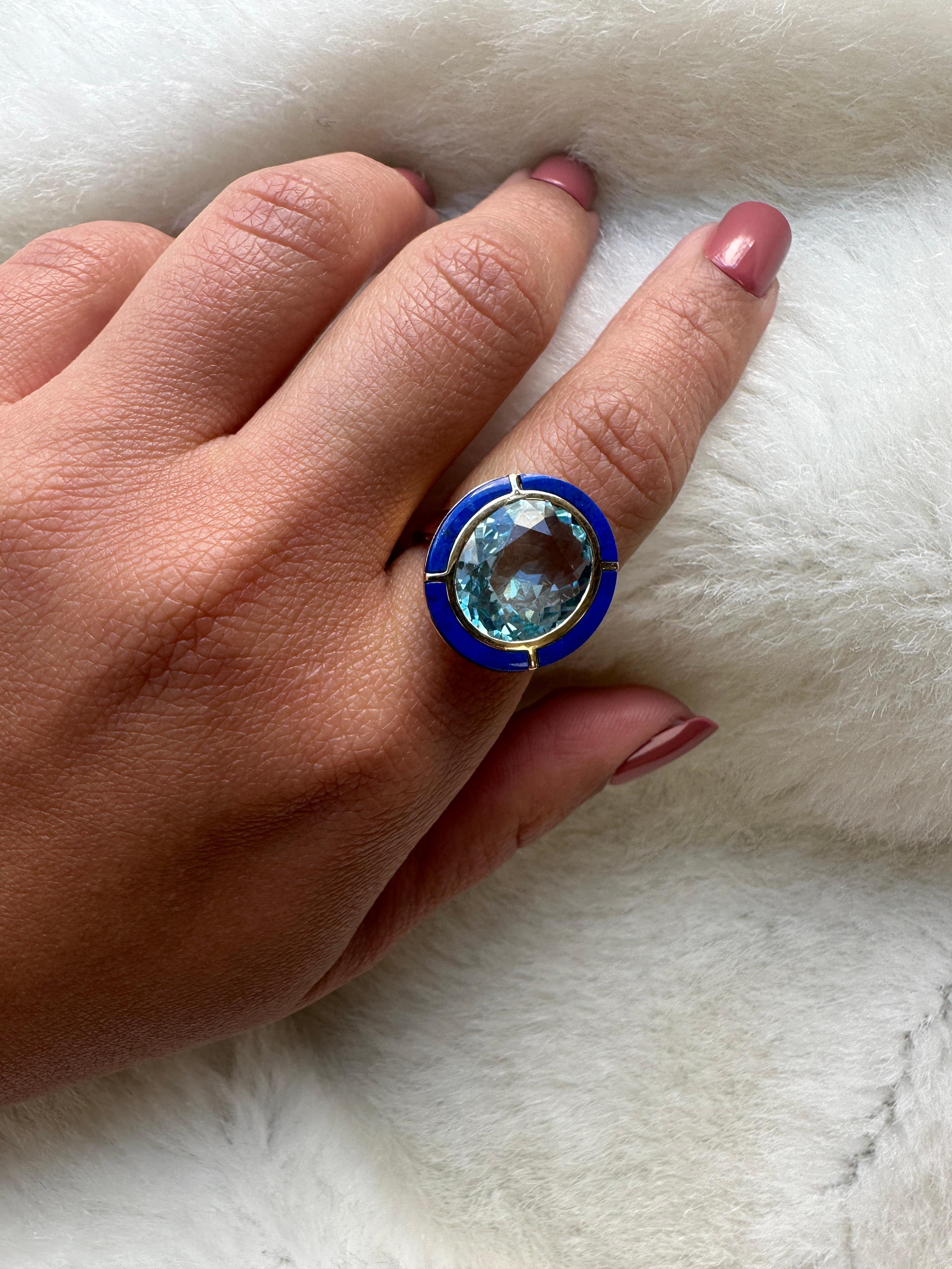 This Blue Topaz & Lapis Lazuli Oval Ring in 18K Yellow Gold is a stunning piece of jewelry from the 'Melange' Collection. This ring features a beautiful combination of blue topaz and lapis lazuli, set in 18K yellow gold. The oval-shaped stones are
