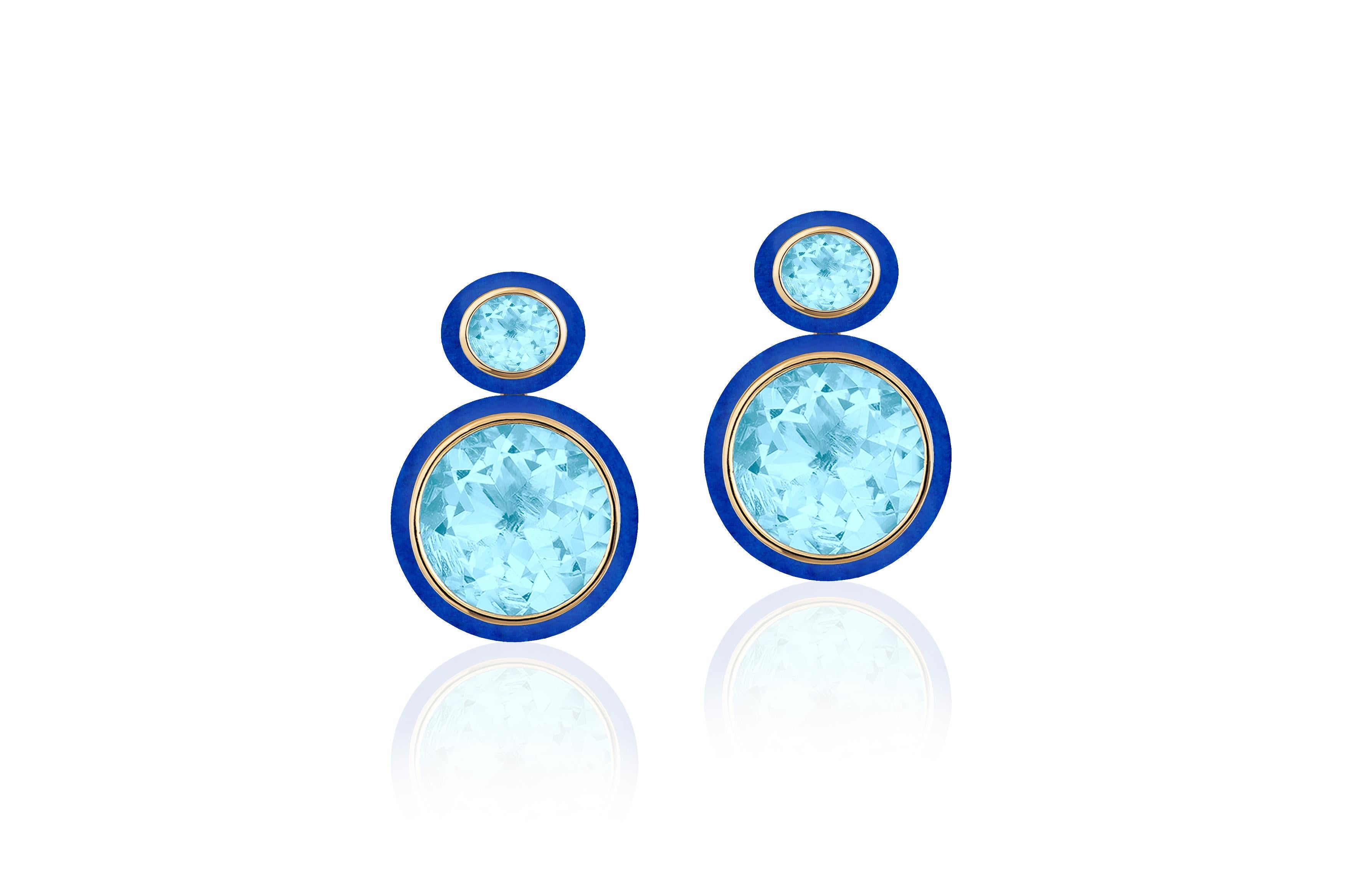 These Oval Shape Blue Topaz and Lapis Lazuli Earrings in 18K Yellow Gold from the 'Melange' Collection are a stunning piece of jewelry. The earrings feature two oval-shaped Blue Topaz gemstones with a Lapis Lazuli Border- set in a rich 18K yellow