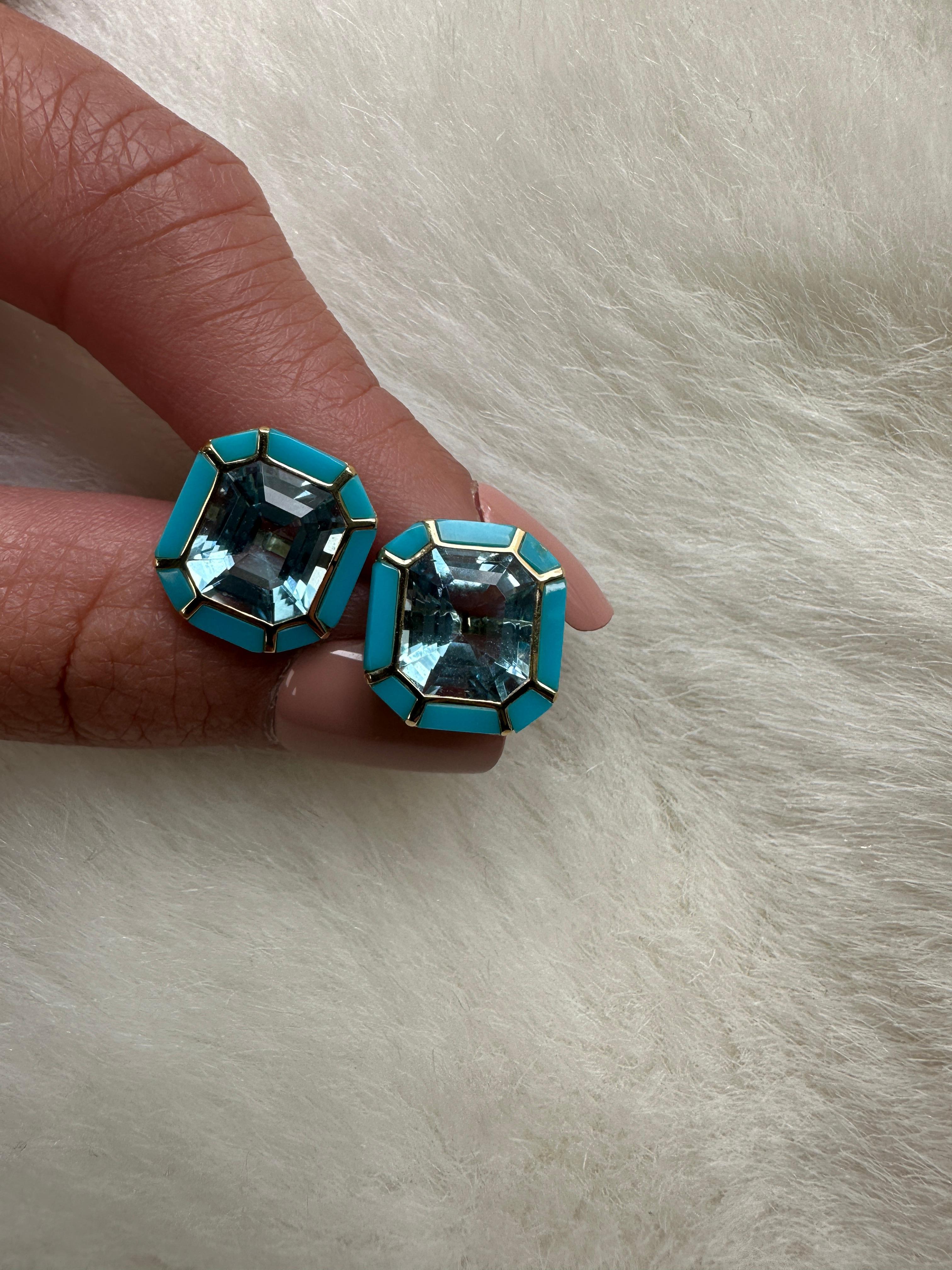 The Blue Topaz & Turquoise Stud Earrings from the 'Melange' Collection showcase a captivating blend of elegance and charm. Crafted with exquisite attention to detail, these earrings feature stunning emerald cut Blue Topaz and Turquoise gemstones set
