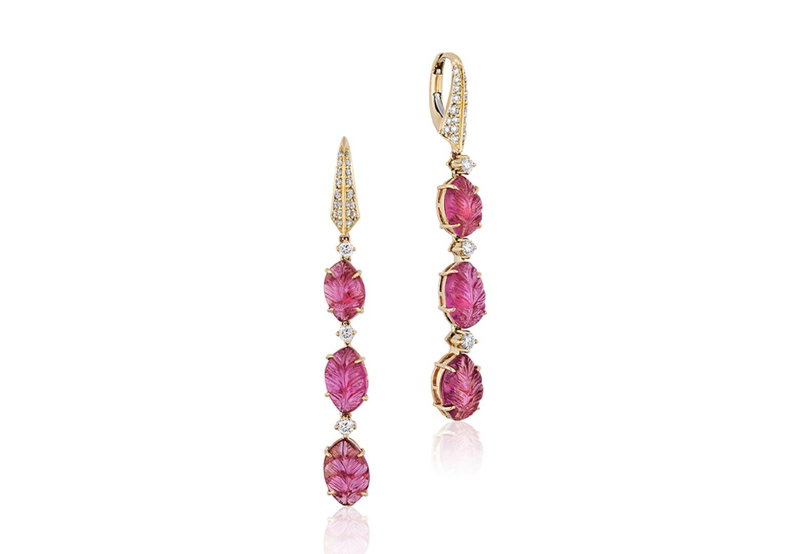 These Carved Rubelite Leaf Earrings with Diamonds from the 'G-One' Collection are a stunning pair of earrings made from 18K yellow gold. The earrings feature intricately carved rubelite gemstones in the shape of delicate leaves, which are