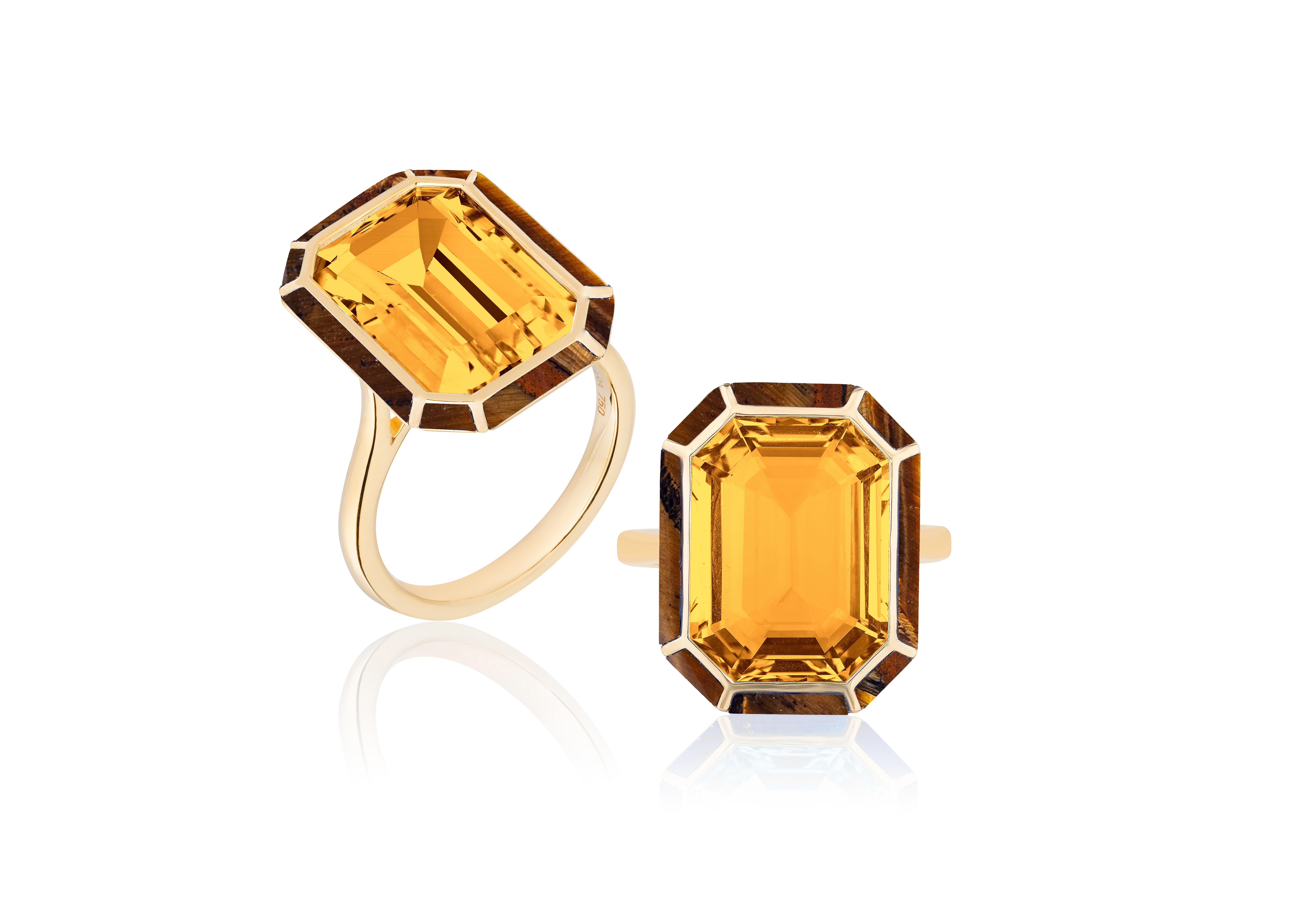 This Citrine and Tiger's Eye Emerald Cut Ring from the 'Mélange' Collection is a stunning piece of jewelry made from 18K yellow gold. The ring features a unique combination of citrine and tiger's eye gemstones in an emerald cut, which creates a