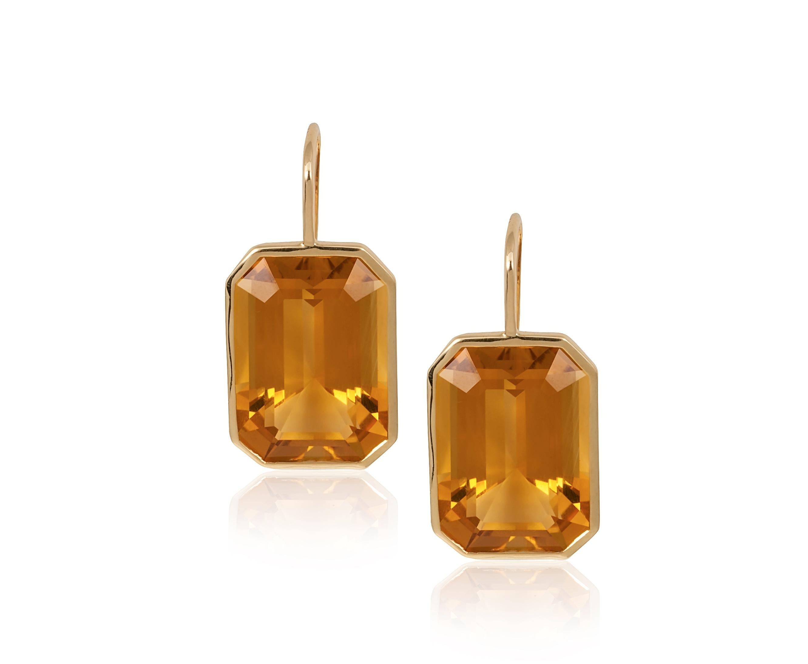 These Citrine Emerald Cut Earrings on Wire in 18K Yellow Gold are a stunning piece of jewelry from the 'Gossip' Collection. These earrings feature beautifully cut citrine stones set in 18K yellow gold wire, which elegantly hangs from the earlobe.