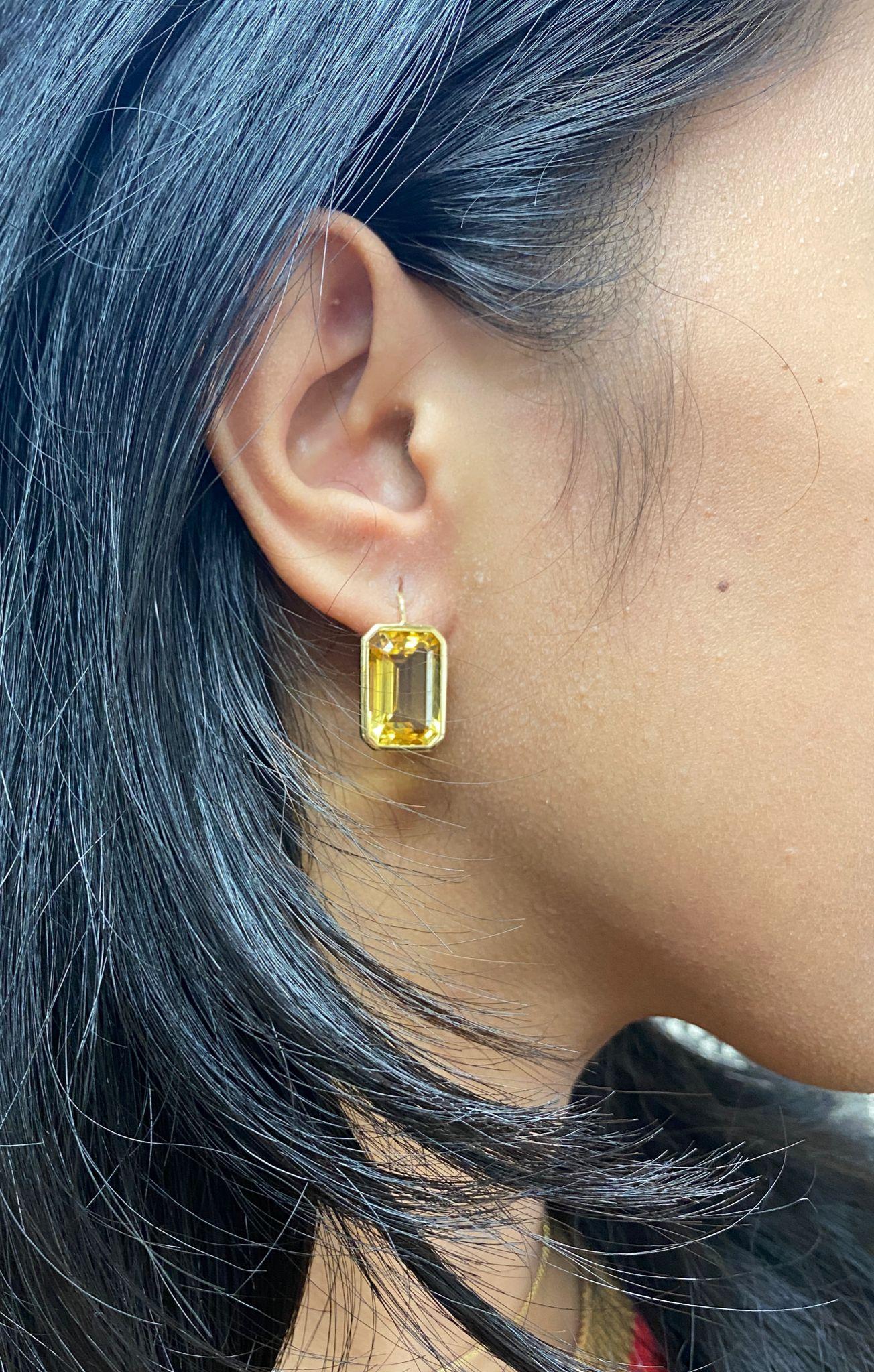 These Citrine Emerald Cut Earrings on Wire in 18K Yellow Gold are a stunning piece of jewelry from the 'Gossip' Collection. These earrings feature beautifully cut citrine stones set in 18K yellow gold wire, which elegantly hangs from the earlobe.
